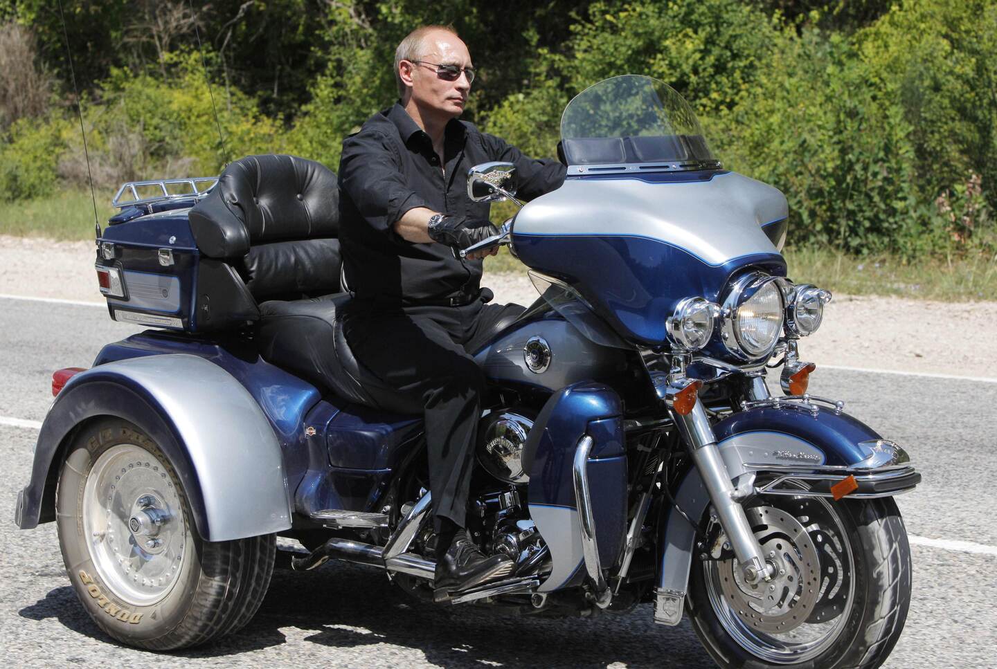 (FILES) In this file photo taken on July 24, 2010 Russian Prime Minister Vladimir Putin rides Harley Davidson Lehman Trike as he leaves the meeting with motorbikers at their camp at Gasfort Lake near Sevastopol in Ukraine's Crimea Peninsula. - Twenty years ago on Friday, Russian president Boris Yeltsin appointed his fourth prime minister in less than 18 months: Vladimir Putin, then a relatively unknown security services chief with scant experience of politics. (Photo by ALEXANDER ZEMLIANICHENKO / POOL / AFP)