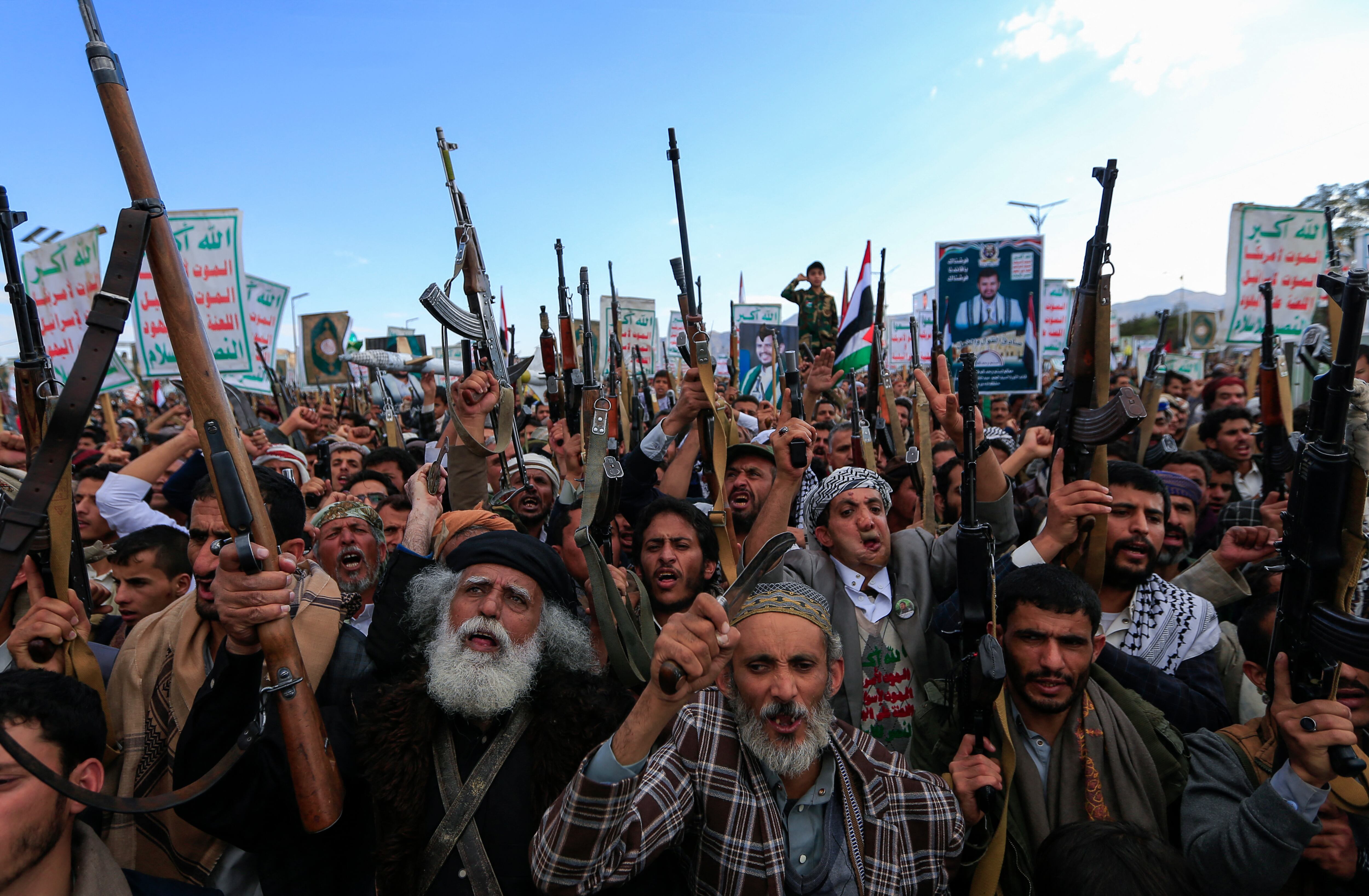 Yemenis brandish rifles and chant during a demonstration called for by the rebel Huthi movement in Sanaa on March 17, 2025. Huge crowds joined protests in rebel-controlled Yemen on March 17 a