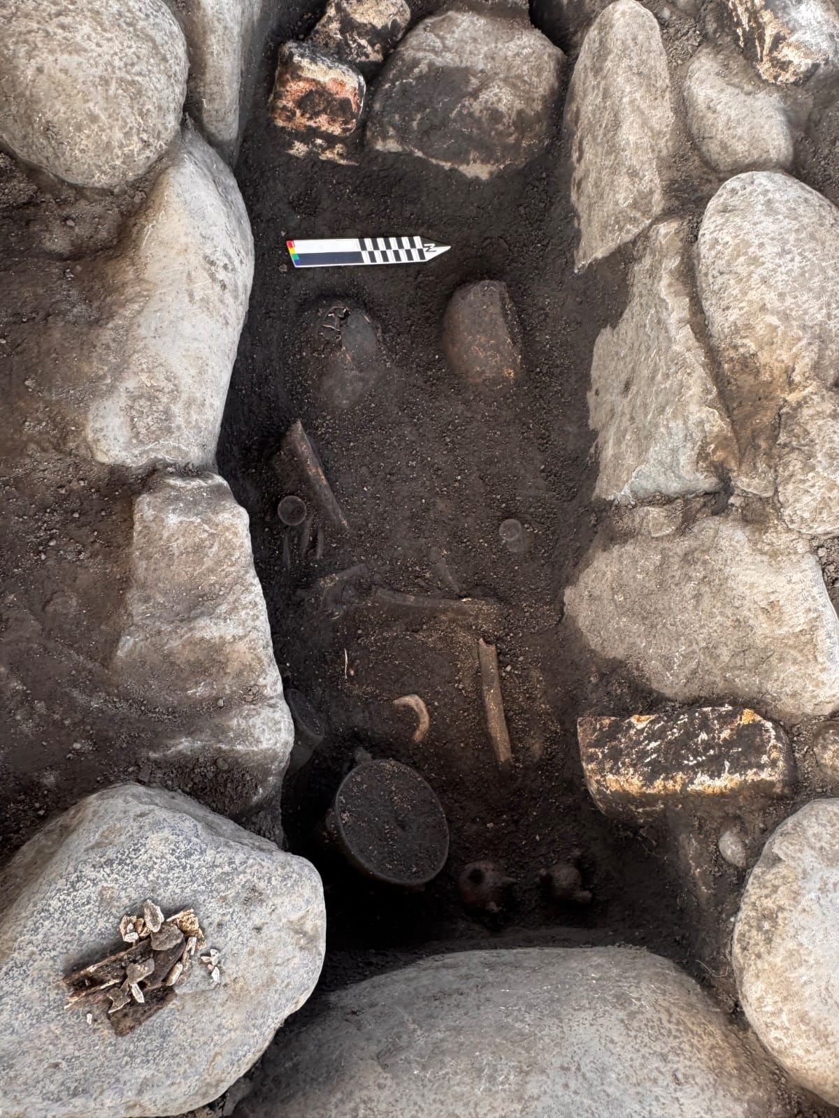 Una fosa donde hay huesos humanos y objetos.
