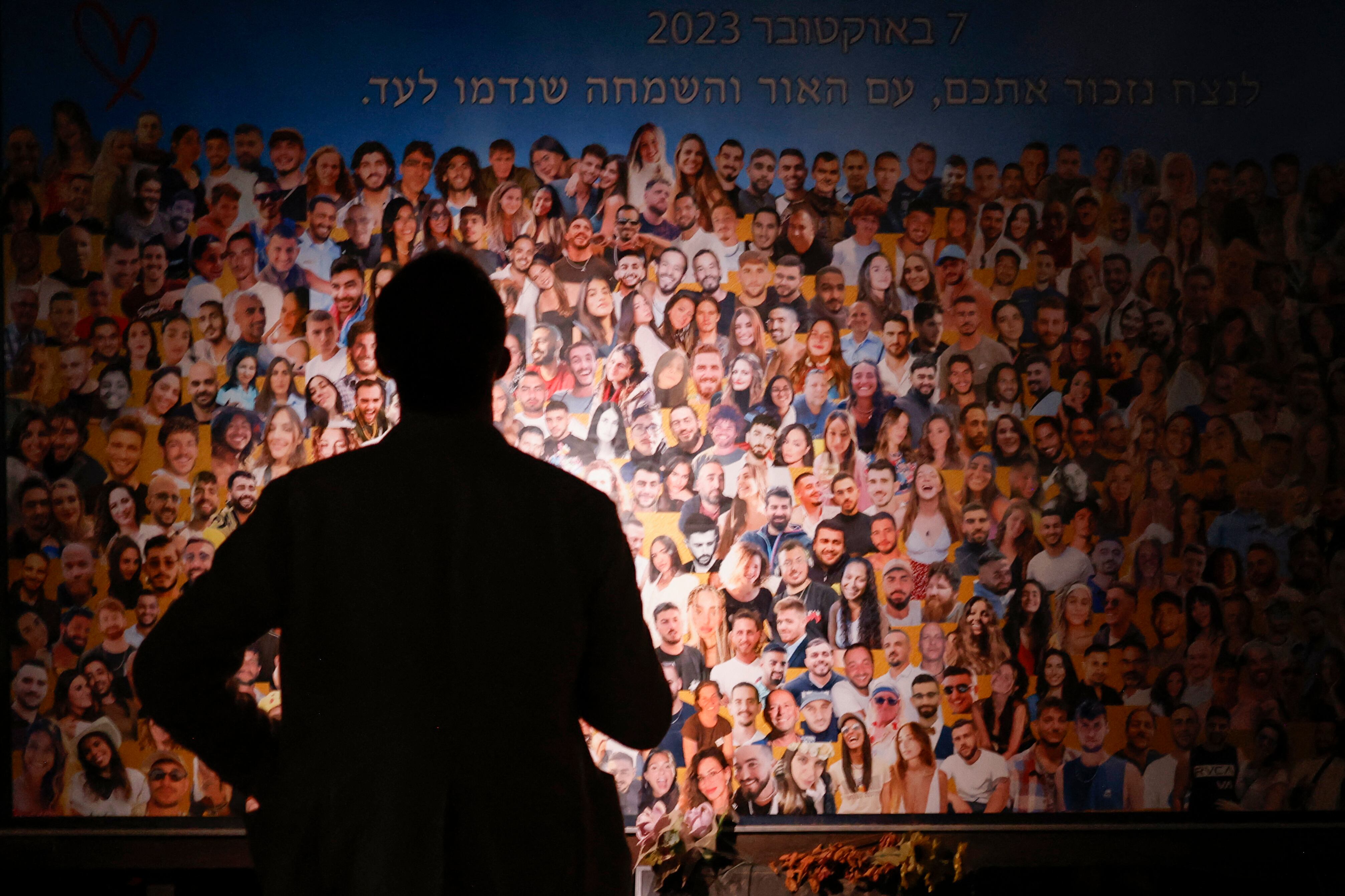 Una persona observa un collage mientras familiares y partidarios de los rehenes israelíes, tomados por militantes palestinos durante el ataque de Hamas del 7 de octubre, asisten al monumento Nova cerca del Kibbutz Reim en el sur de Israel.