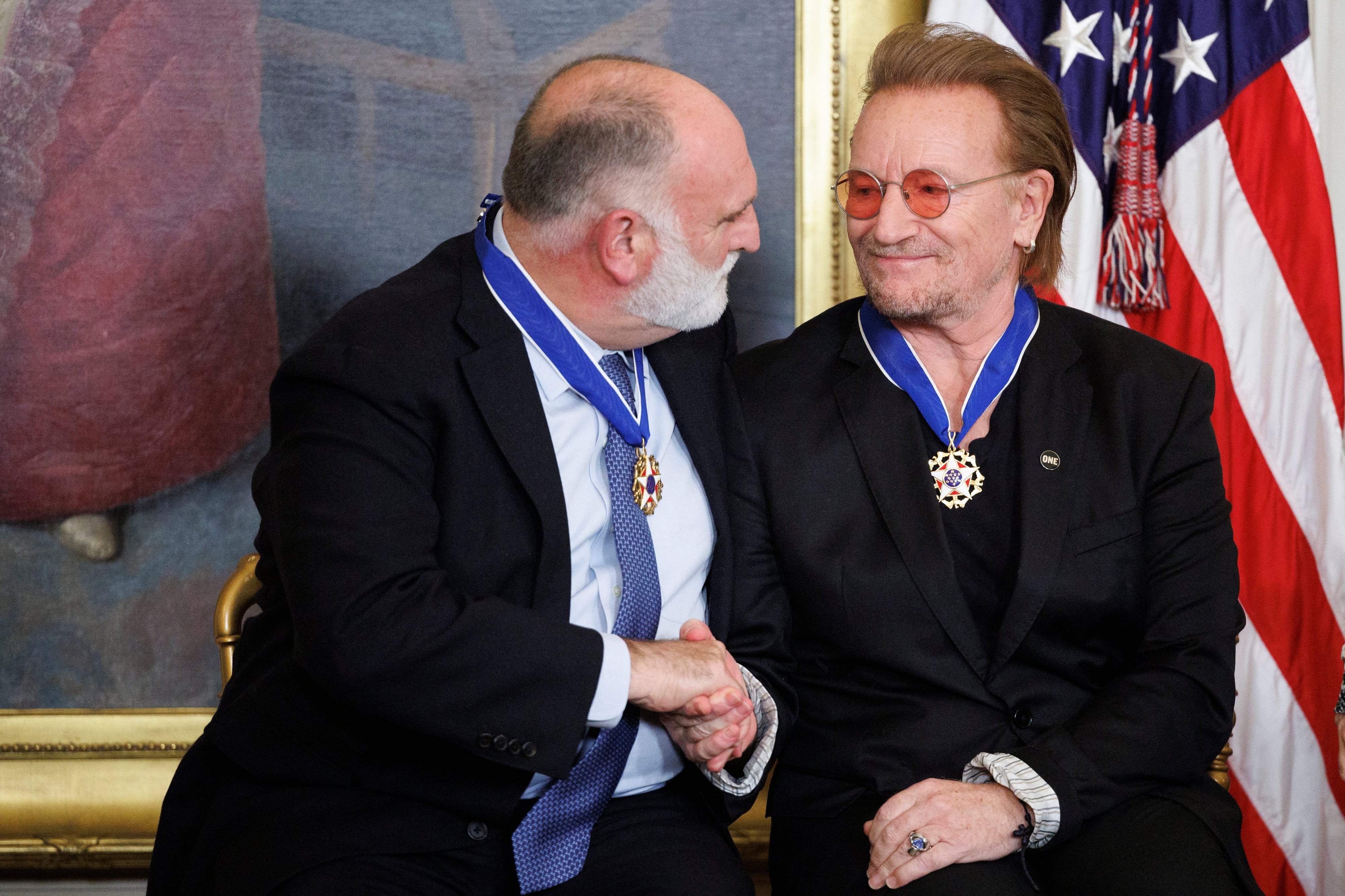 El chef Jose Andres y el músico Bono se saludan de mano después de recibir las Medallas de la Libertad.
