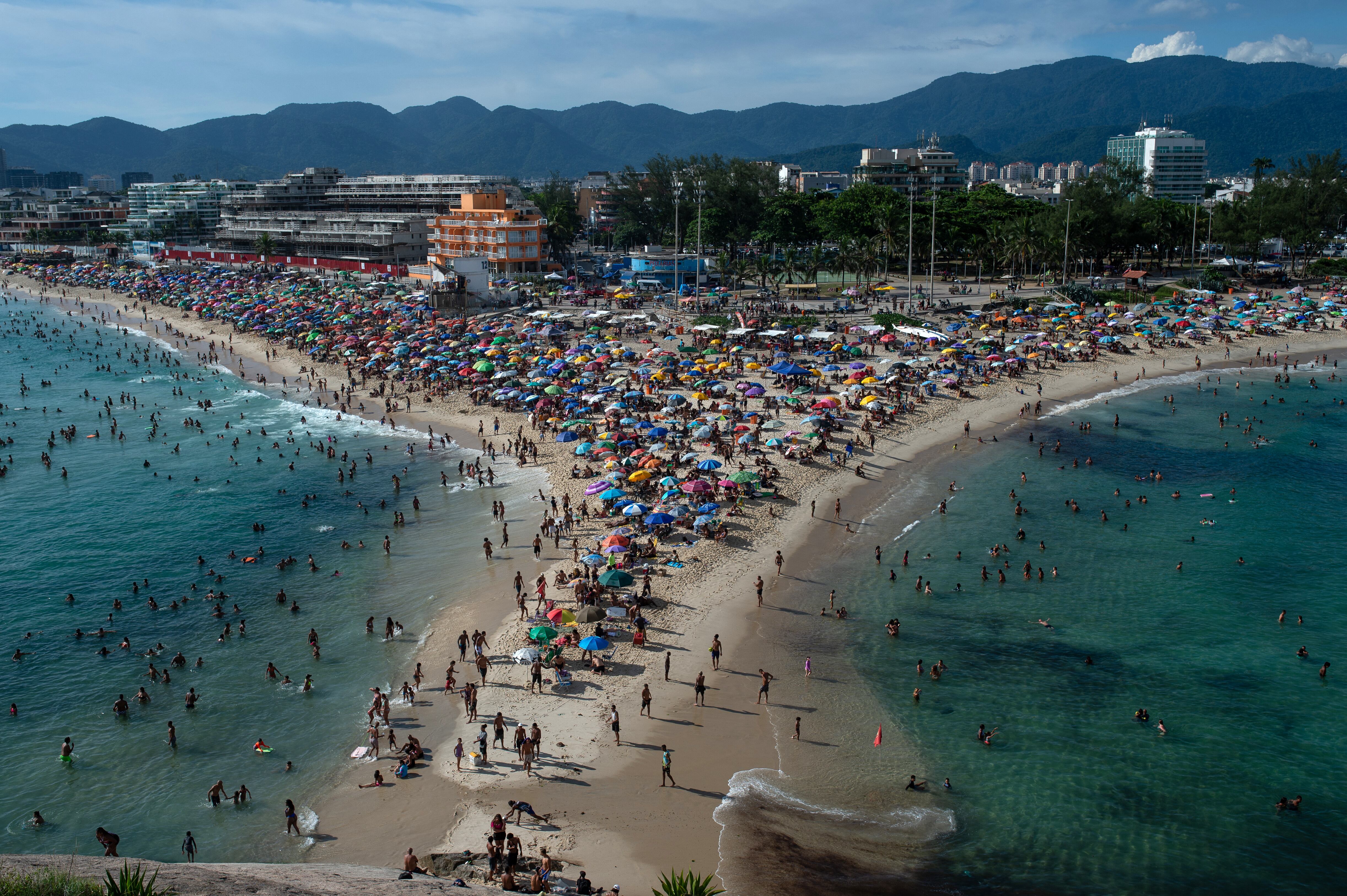 Aerial view of people enjoying Recreio dos Bandeirantes beach in Rio de Janeiro, Brazil, on February 8, 2025. (Photo by Tercio TEIXEIRA / AFP)