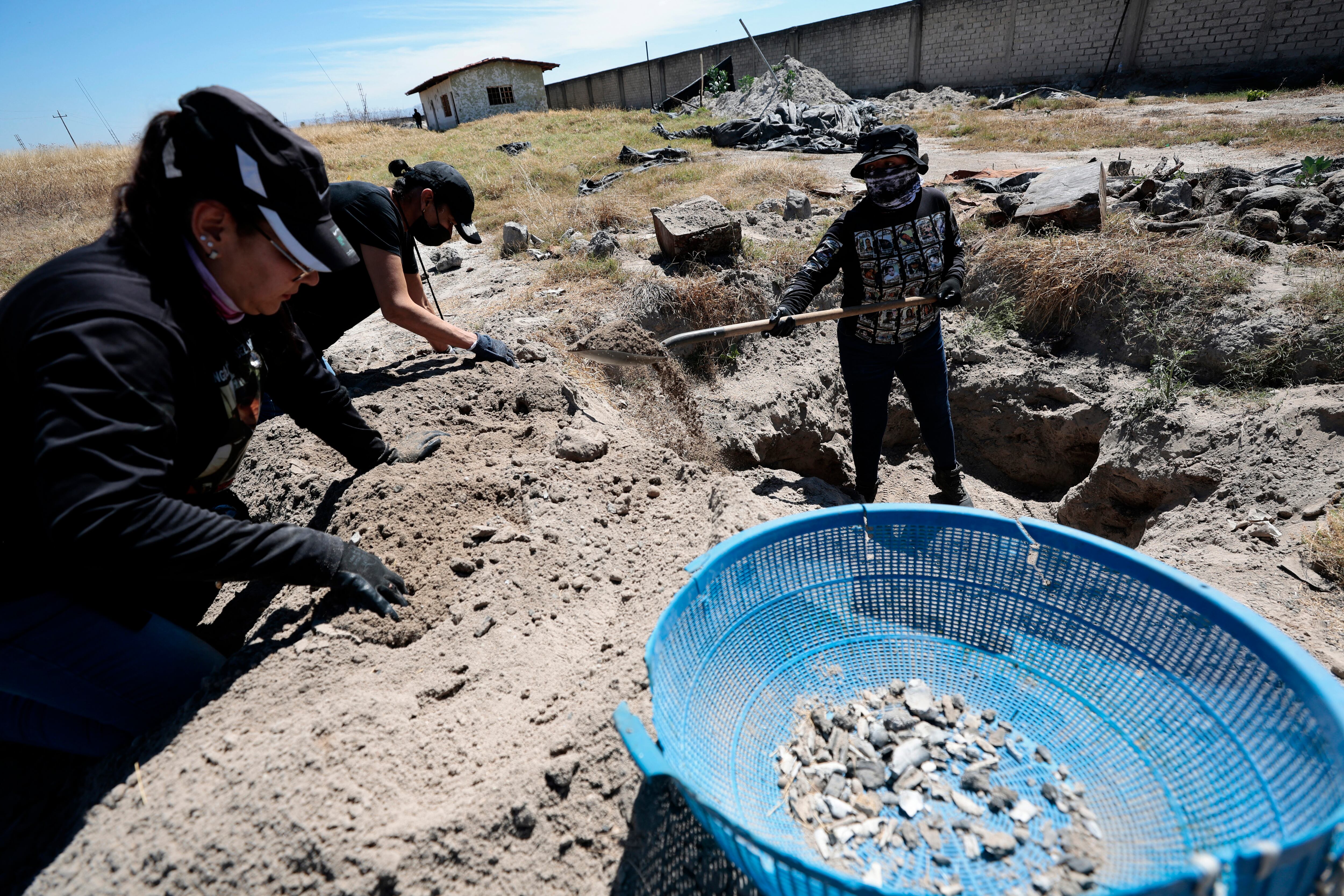 Members of the collective 'Guerreros Buscadores' work on three human crematoriums found while searching for their relatives at Izaguirre Ranch in the community La Estanzuela in Teuchitlan, Jalisco state, Mexico on March 5, 2025. Mexico's Attorney General's Office and the federal government will inv
