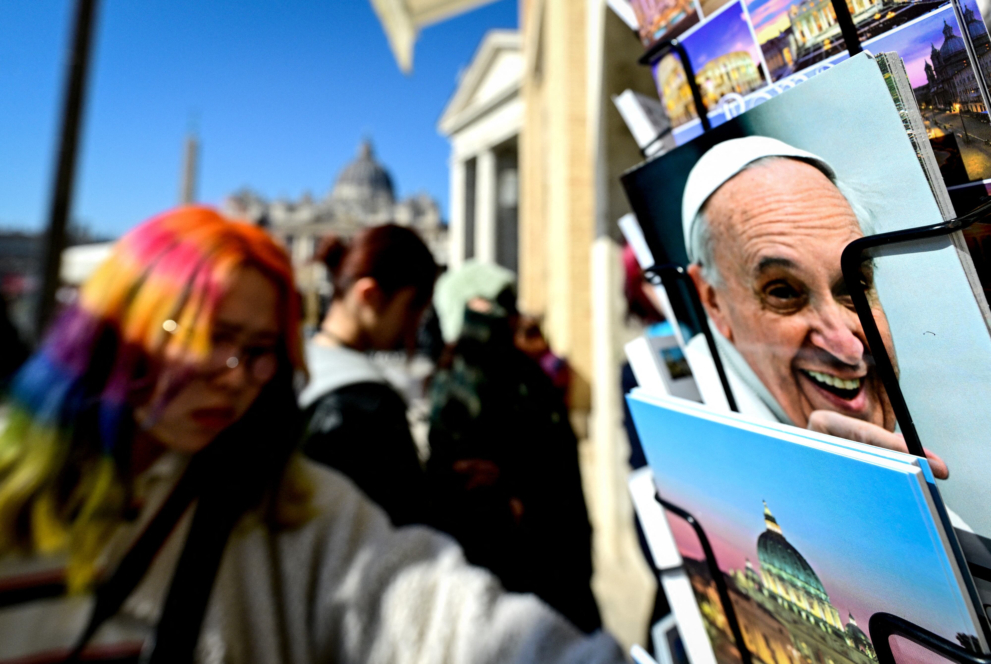 Postcards of Pope Francis are on sale Via della Conciliazione leading to St Peter's basilica during the Jubilee year, on February 21, 2025. Pope Francis passes another calm night in hospital, the Vatican said on February 21, 2025 in its morning update, as the 88-year-old spent his seventh day in hospital being treated for pneumonia. (Photo by Tiziana FABI / AFP)