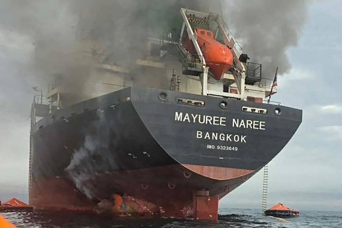 This handout photo taken on March 11, 2026 and released by the Royal Thai Navy shows smoke rising from the Thai bulk carrier 'Mayuree Naree' near the Strait of Hormuz after an attack. A Thai bulk carrier travelling in the crucial Strait of Hormuz was attacked March 11, with 20 crew members rescued so far, the Thai navy said. (Photo by Handout / ROYAL THAI NAVY / AFP) / -----EDITORS NOTE --- RESTRICTED TO EDITORIAL USE - MANDATORY CREDIT "AFP PHOTO / ROYAL THAI NAVY " - NO MARKETING - NO ADVERTISING CAMPAIGNS - DISTRIBUTED AS A SERVICE TO CLIENTS -