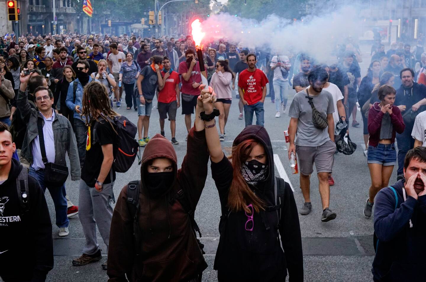 Pro independence demonstrators march during a protest in Barcelona, Spain, on Monday, Oct. 1, 2018. Pro-secession activists in Catalonia have blocked major highways, train lines and avenues across the northeastern region on the anniversary of a banned referendum that was crushed by police and failed to deliver independence from Spain. (AP Photo/Daniel Cole)