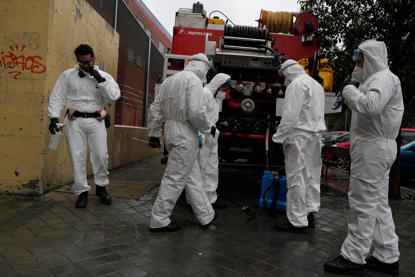 Members of the UME (Emergency Army Unit) wearing protective suits to protect from coronavirus prepare to disinfect at a nursing home in Madrid, Spain, Tuesday, March 31, 2020. The new coronavirus causes mild or moderate symptoms for most people, but for some, especially older adults and people with existing health problems, it can cause more severe illness or death. (AP Photo/Manu Fernandez)