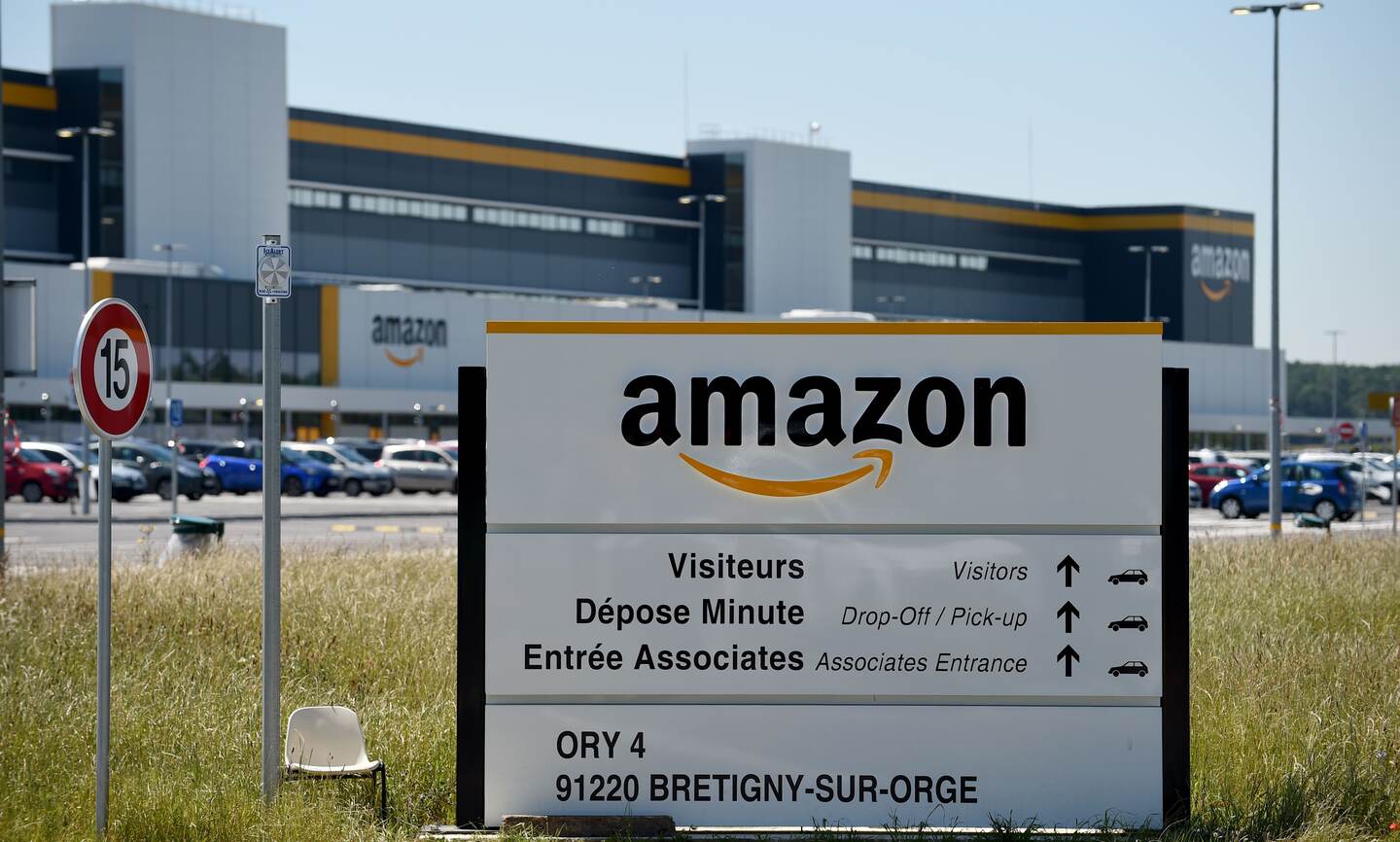 A picture taken in Bretigny-sur-Orge on May 19, 2020 shows a sign with the company's logo at Amazon's centre entrance as Amazon France partially reopens amid the pandemic of the novel coronavirus (COVID-19). - US online retailing giant Amazon resumes operations from May 19 at its warehouses in France that were temporarily closed in a labour dispute over working conditions during the coronavirus pandemic, announced the group on May 15, 2020. (Photo by ERIC PIERMONT / AFP)
