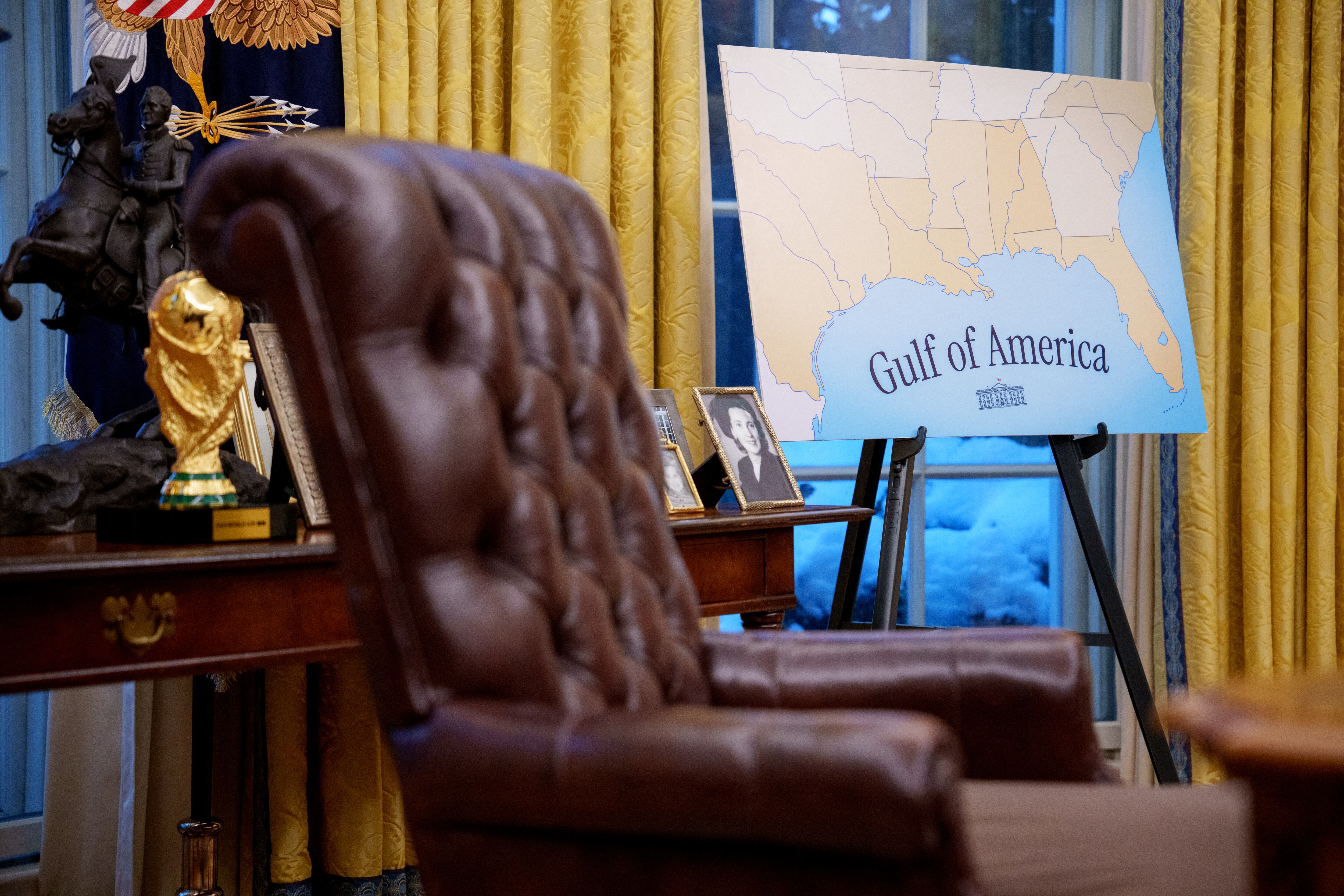 WASHINGTON, DC - FEBRUARY 12: A poster depicting the Gulf of Mexico as the newly renamed "Gulf of America" is visible behind the Resolute Desk during a swearing in ceremony for Tulsi Gabbard as Director of National Intelligence in the Oval Office at the White House on February 12, 2025 in Washington, DC.