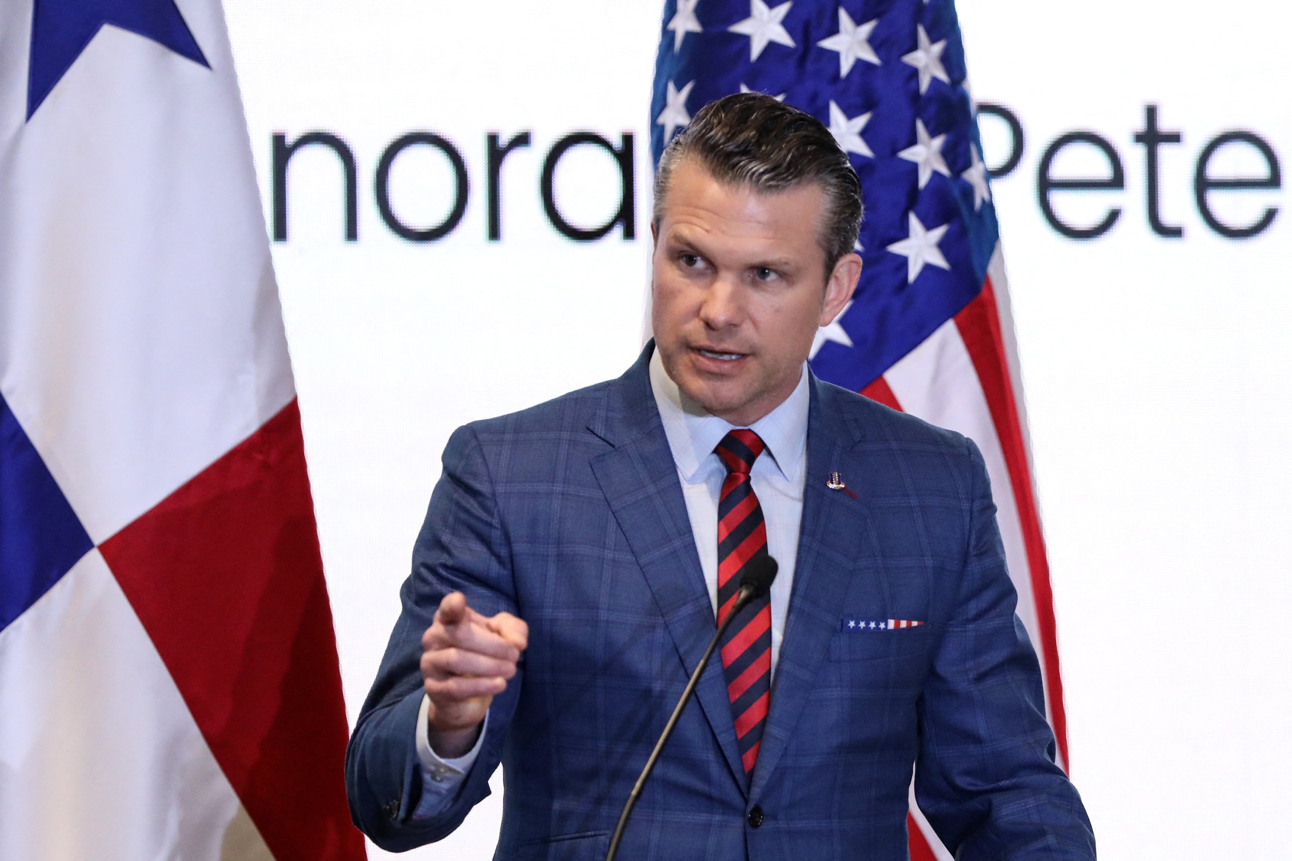 US Secretary of Defense Pete Hegseth (R) talks with Panama Canal Administrator Ricaurte Vasquez during a visit to the Miraflores locks of the Panama Canal in Panama City on April 8, 2025. (Photo by MARTIN BERNETTI / AFP)