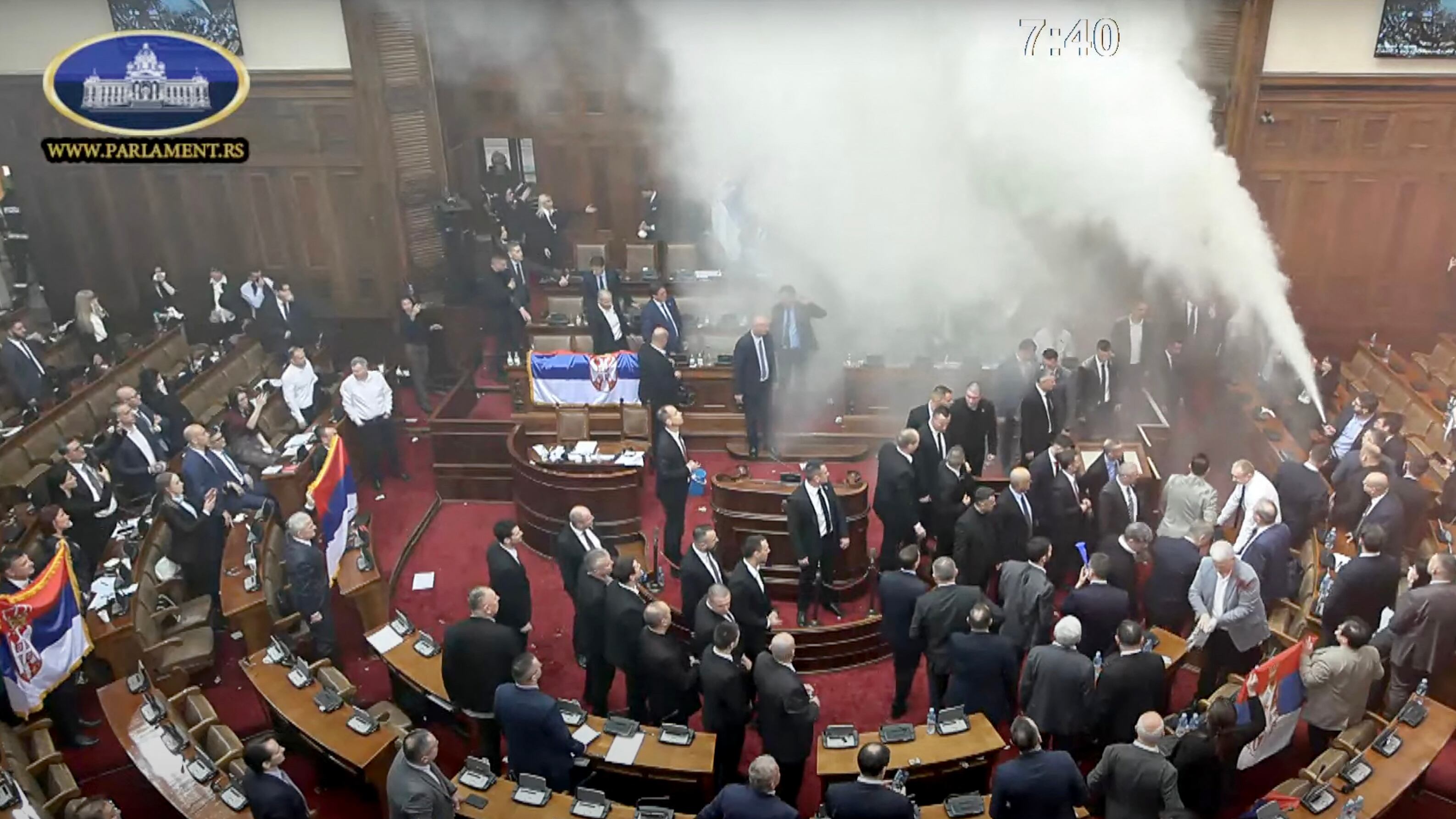 This frame grab from handout video footage taken and released by the National Assembly of the Republic of Serbia in Belgrade on March 4, 2025 shows Serbian opposition lawmakers activating a fire extinguisher during the opening day of the spring ses