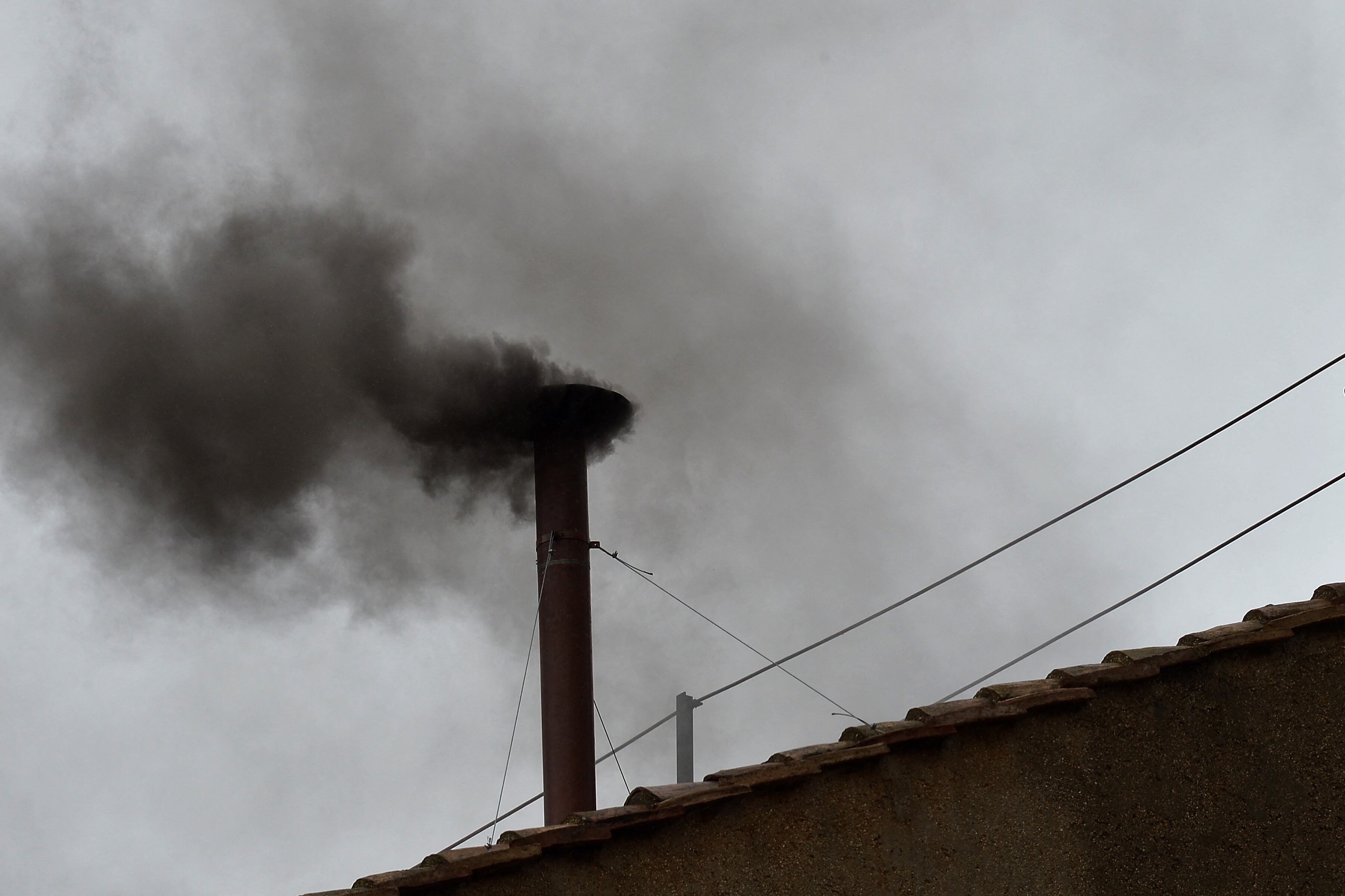 (FILES) Black smoke rises from the chimney on the roof of the Sistine Chapel meaning that cardinals failed to elect a new pope in the second ballot of their secret conclave on March 13, 2013 at the Vatican. Pope Francis died on April 21, 2025 aged 88, a day after making a much hoped-for appearance at Saint Peter's Square on Easter Sunday, the Vatican said in a statement. (Photo by Vincenzo PINTO / AFP)