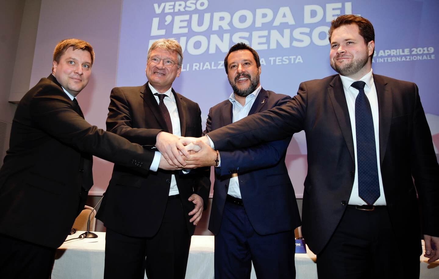 From left, Olli Kotro, leader of The Finns Party, Jörg Meuthen, leader of Alternative For Germany party, Matteo Salvini, Italian deputy-Premier and leader of the League party, and Anders Vistisen, leader of the Danish People's Party, join hands prior to the start of a press conference, in Milan, Monday, April 8, 2019. Salvini, Italy's hard-line vice Premier, is meeting with like-minded leaders of European right-wing party as he seeks to form a broad alliance ahead of the European elections next month. (AP Photo/Luca bruno)