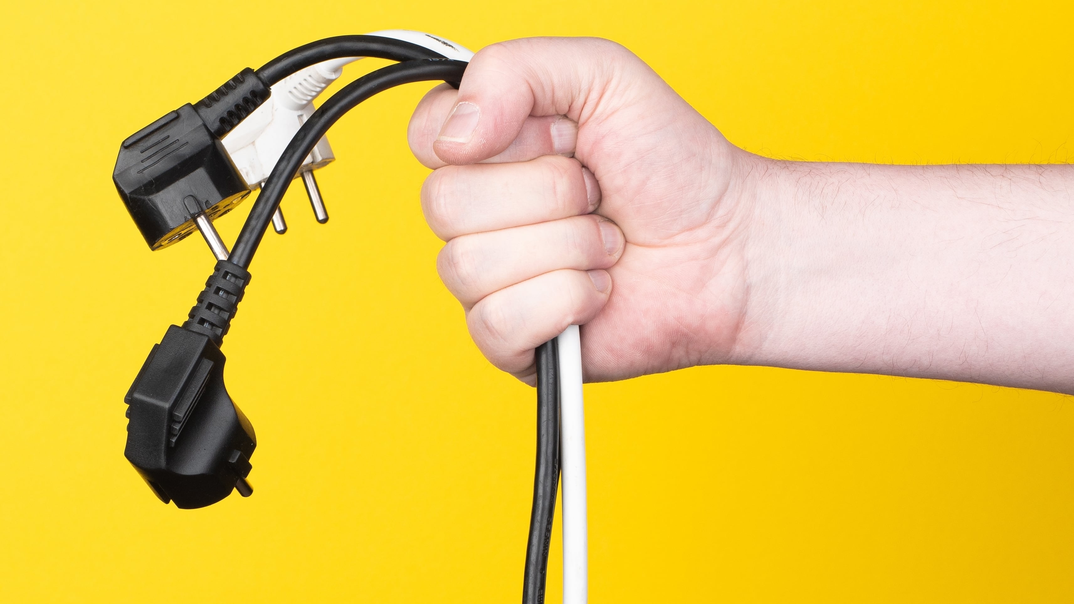 enchufes, mano sostiene varios enchufes, personas enchufadas