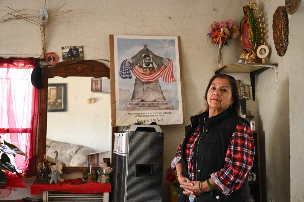 Farmworker Lourdes Cardenas stands for a portrait in her home in Fresno, California, on February 12, 2025. With planting season well under way in California, the largest agriculture-producing state in the US, fear is taking root among thousands of migrants who labor to feed a country that now seems ready to deport them. "We have to stay hidden," Lourdes Cardenas, a 62-year-old Mexican living in Fresno told AFP. "You are unsure if you will encounter the immigration authorities. We can't be free anywhere, not in schools, not in churches, not in supermarkets," said Cardenas, who has been in the United States for 22 years. (Photo by Patrick T. Fallon / AFP)
