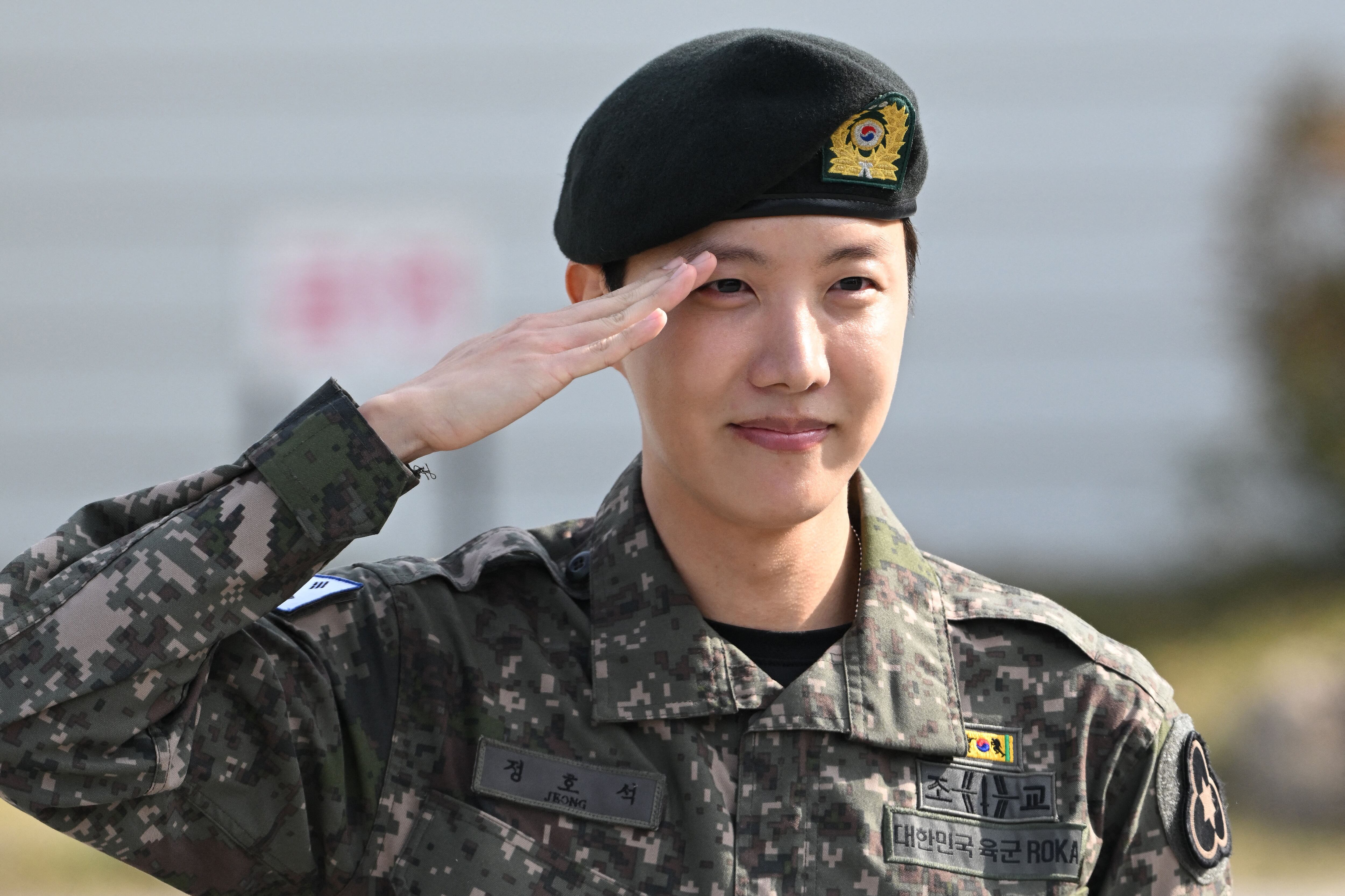 BTS member J-hope salutes after being discharged from his mandatory military service outside a military base in Wonju on October 17, 2024. K-pop megastar J-hope from BTS ended eighteen months of South Korean military service on October 17, and hailed the "sacrifice" of soldiers working to keep the country safe, as fans wept for joy at his return to the industry. (Photo by JUNG YEON-JE / AFP)
