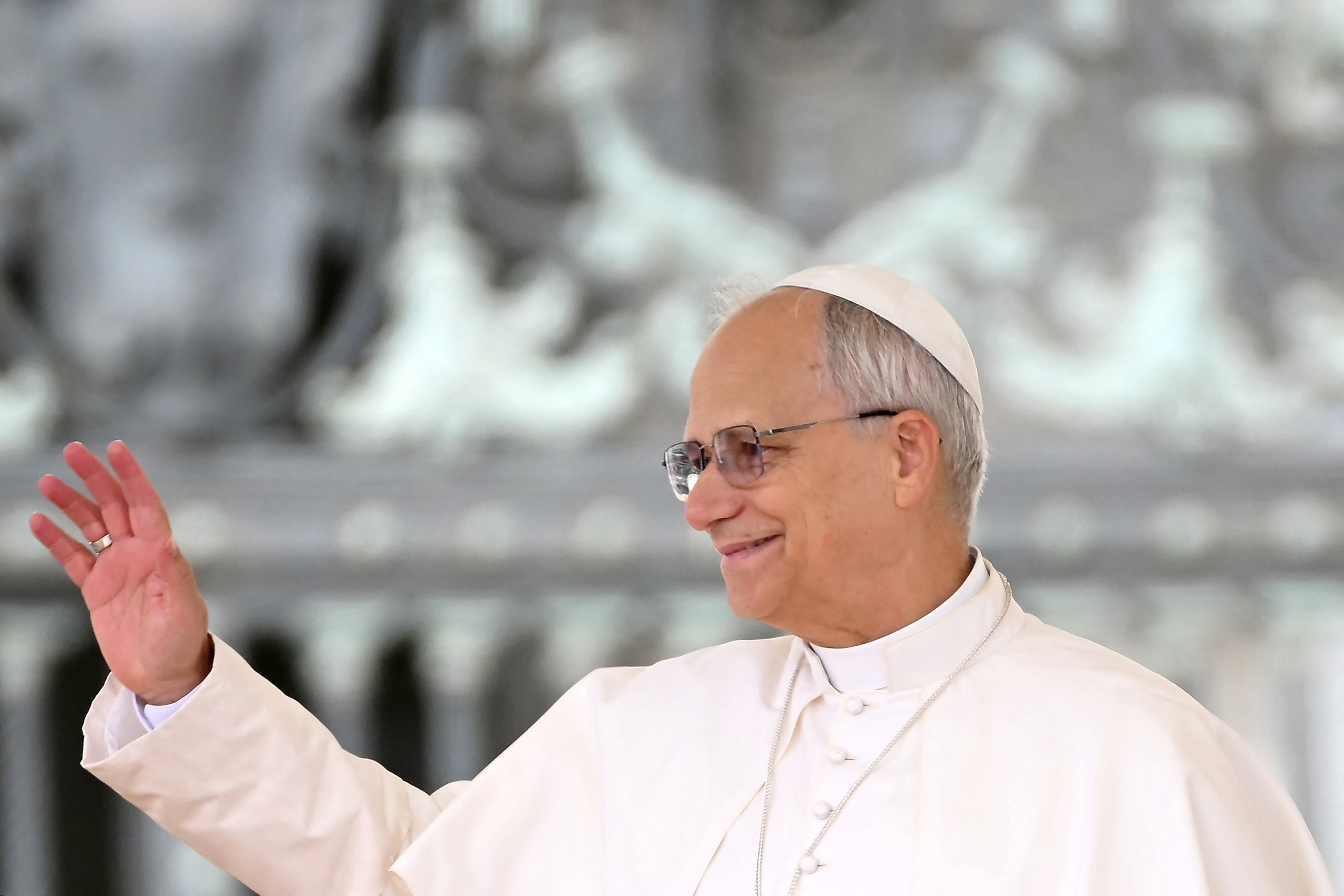 Pope Leo XIV waves to pilgrims during the Weekly General Audience at the Vatican
