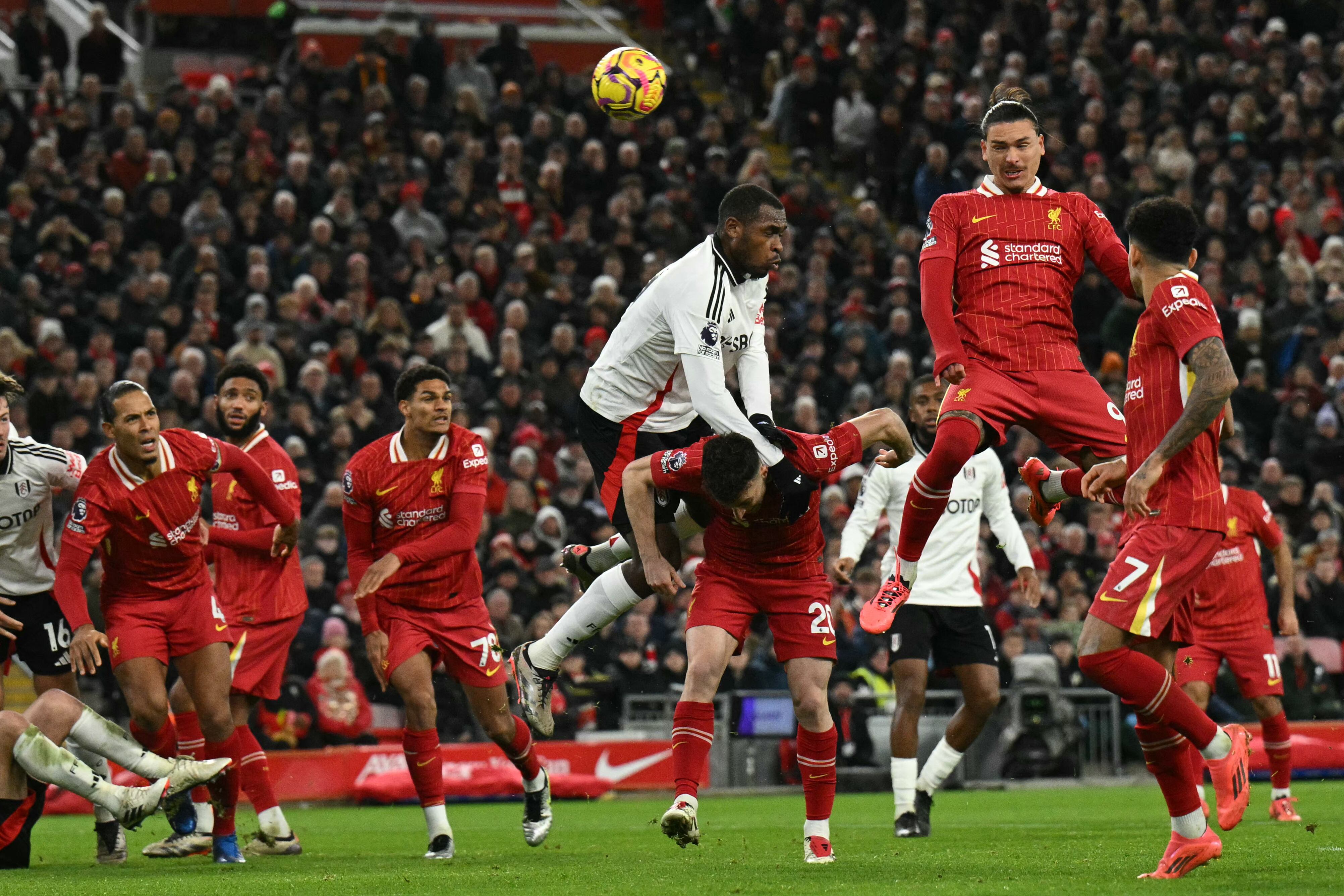 Liverpool's Uruguayan striker #09 Darwin Nunez (2R) fails to hit the target with this header during the English Premier League football match between Liverpool and Fulham at Anfield in Liverpool, north west England on December 14, 2024. (Photo by Oli SCARFF / AFP) / RESTRICTED TO EDITORIAL USE. No use with unauthorized audio, video, data, fixture lists, club/league logos or 'live' services. Online in-match use limited to 120 images. An additional 40 images may be used in extra time. No video emulation. Social media in-match use limited to 120 images. An additional 40 images may be used in extra time. No use in betting publications, games or single club/league/player publications. /