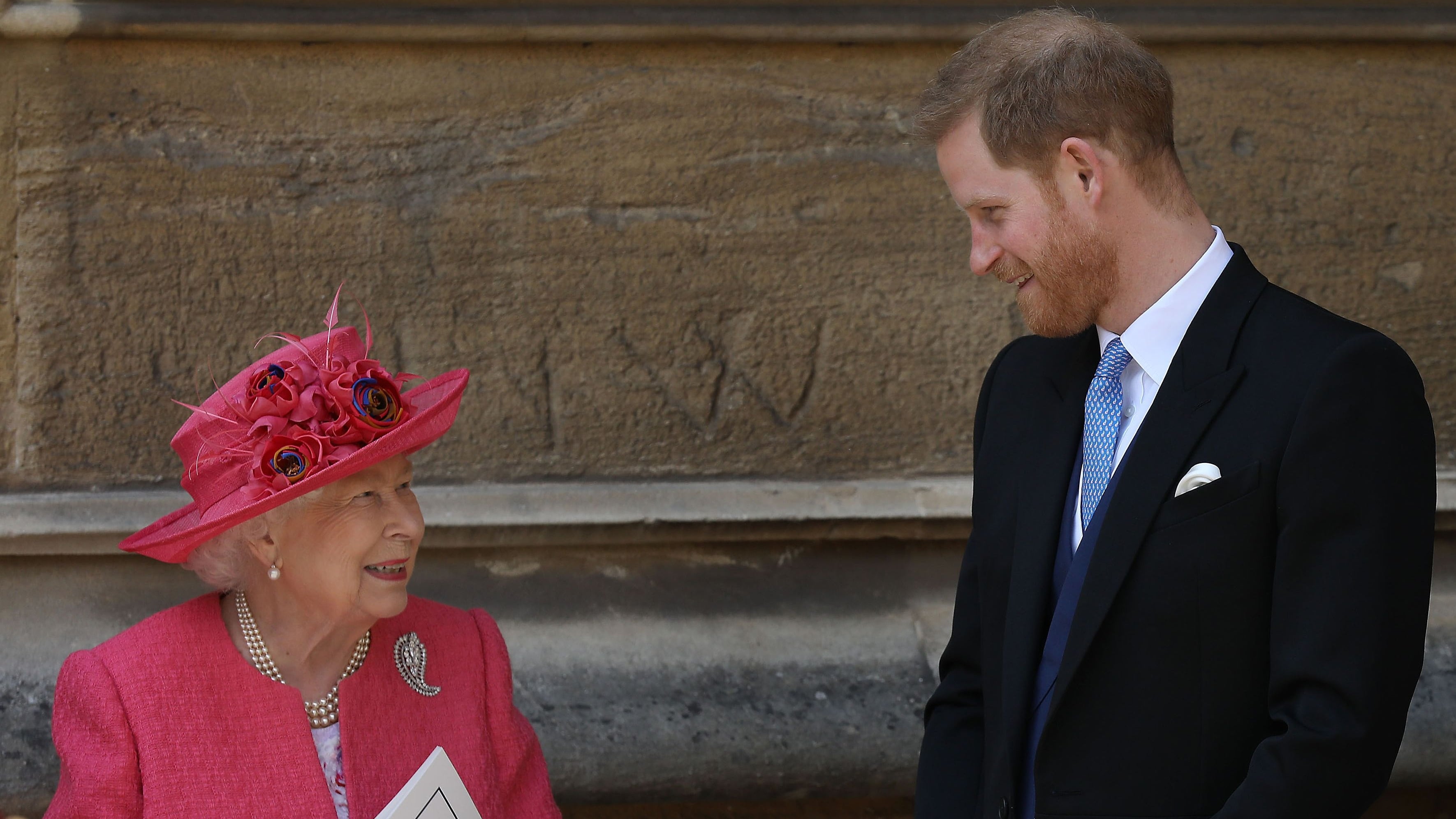 Britain's Queen Elizabeth II chats to Britain's Prince Harry, Duke of Sussex as they leave St George's Chapel in Windsor Castle, Windsor, west of London, on May 18, 2019, after the wedding ceremony of Lady Gabriella Windsor and Thomas Kingston. - Lady Gabriella, is the daughter of Prince and Princess Michael of Kent. Prince Michael, is the Queen Elizabeth II's cousin. (Photo by Steve Parsons / POOL / AFP)