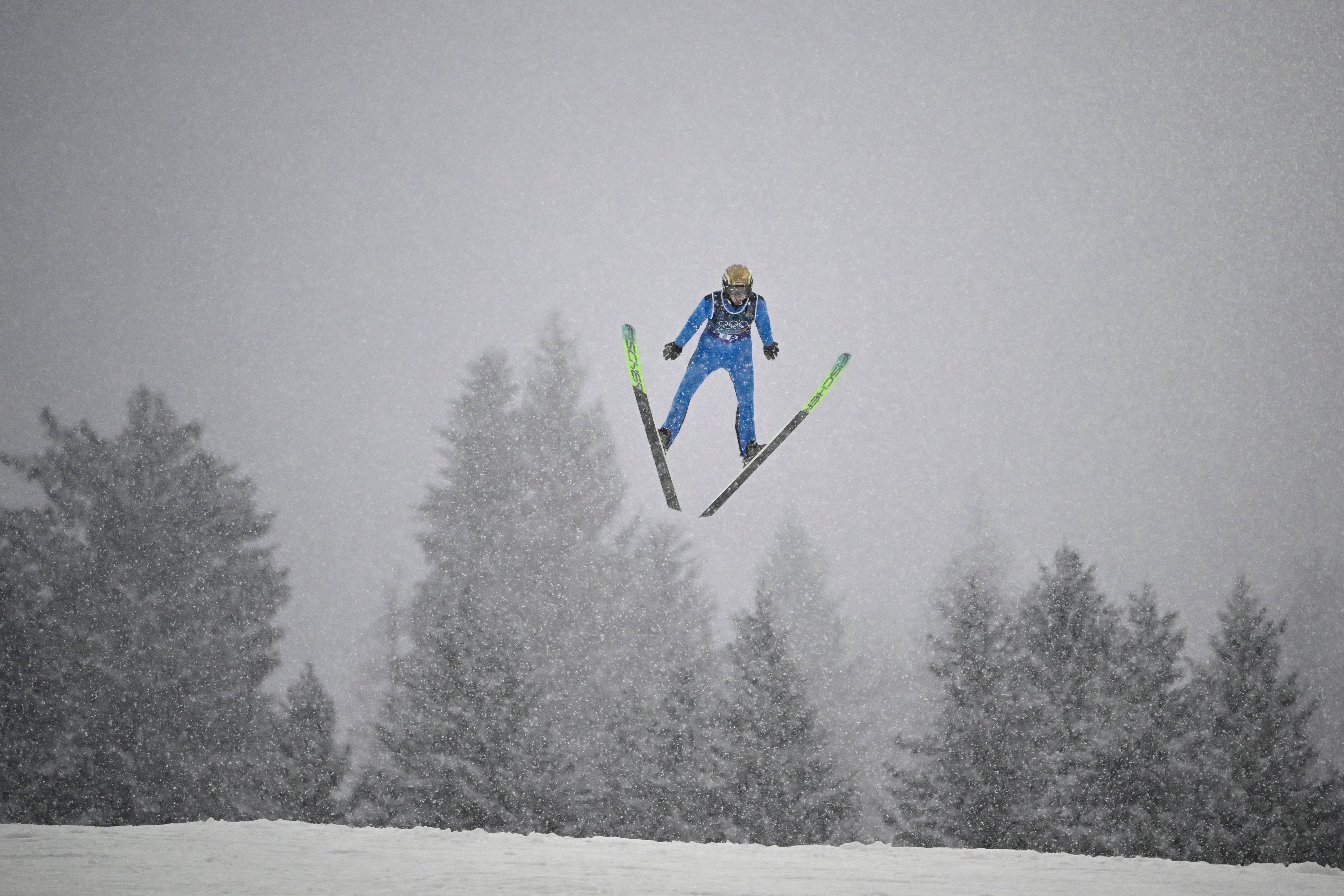 Finland's Ilkka Herola jumps in the ski jumping competition round of the nordic combined team sprint large hill event at Predazzo Ski Jumping Stadium in Predazzo (Val di Fiemme) during the Milano Cortina 2026 Winter Olympic Games on February 19, 2026. (Photo by Tobias SCHWARZ / AFP)
