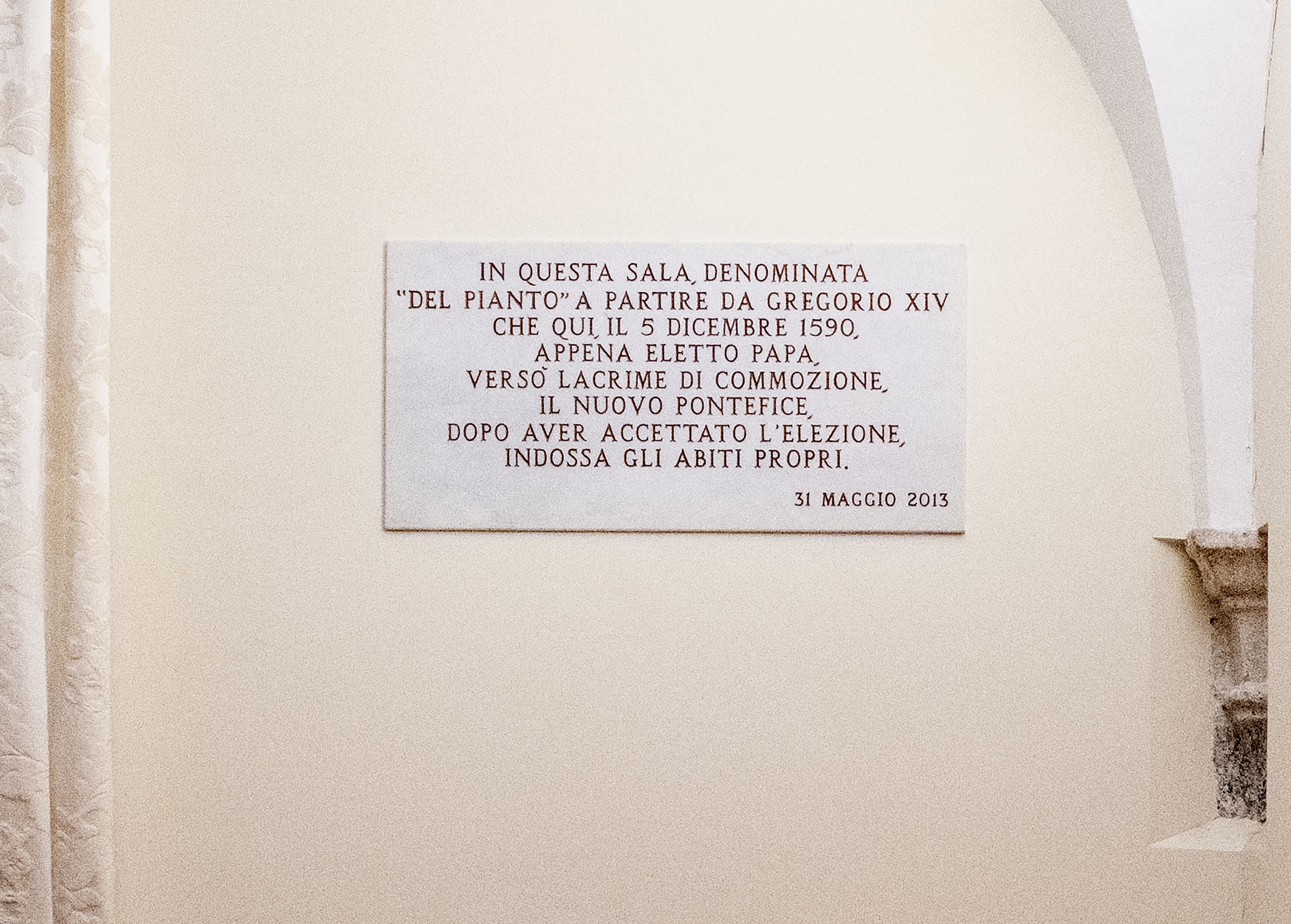 A picture taken on February 13, 2024 shows a plaque in the "room of tears" next to the Sistine Chapel reading : In this room called "the room of tears" after Gregory XIV who shed tears of emotion here on 5 December 1590, just after being elected pope, the new pontiff, after having accepted the election, puts on his own clothes. (Photo by Tiziana FABI / AFP)