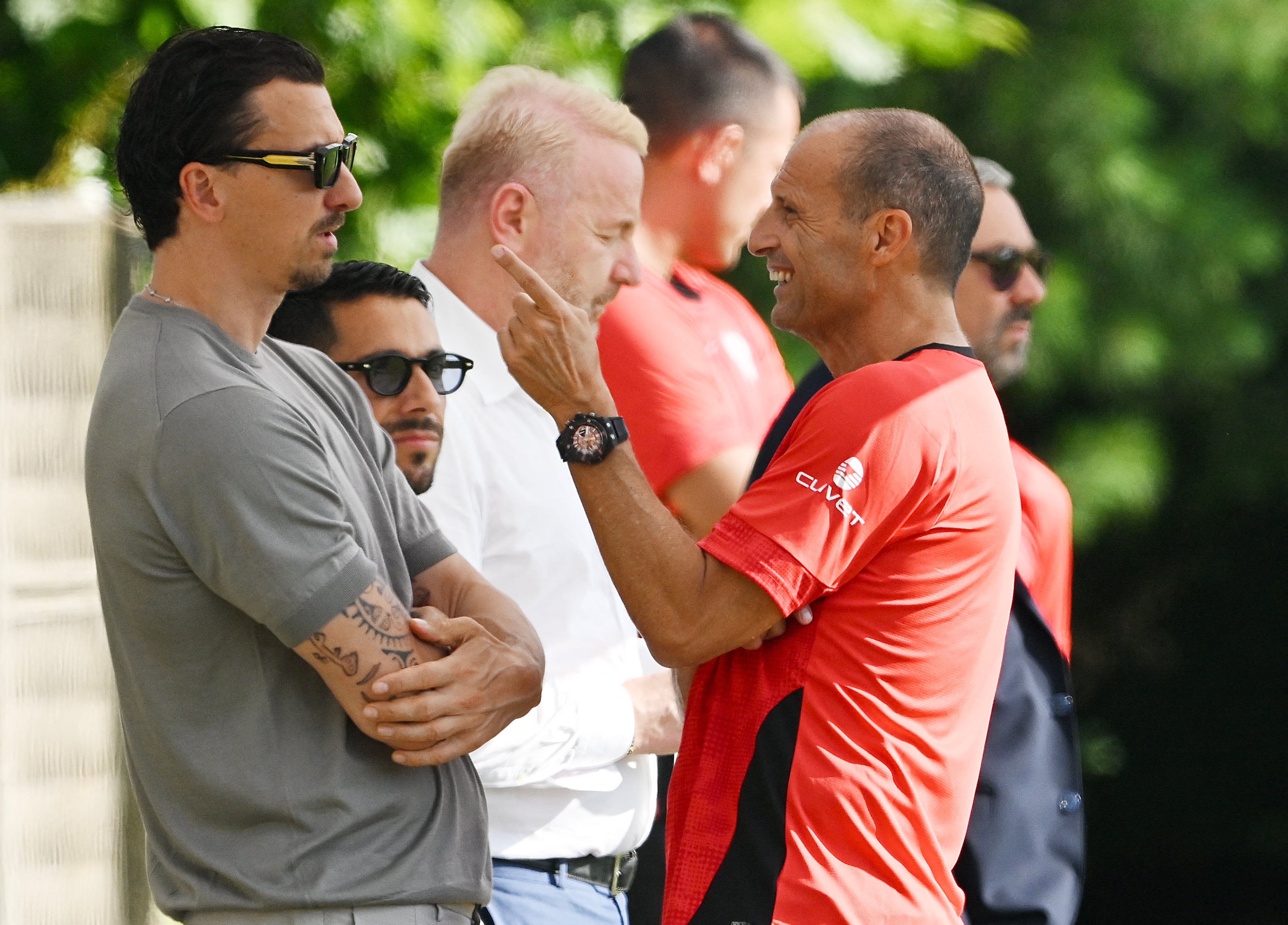 El nuevo entrenador italiano del AC Milan, Massimiliano Allegri (derecha), conversa con el asesor deportivo sueco del club, Zlatan Ibrahimovic, durante una sesión de entrenamiento en el Centro Deportivo Milanello, en Carnago, al noroeste de Milán, el 7 de julio del 2025. (Foto de Stefano Rellandini / AFP)
