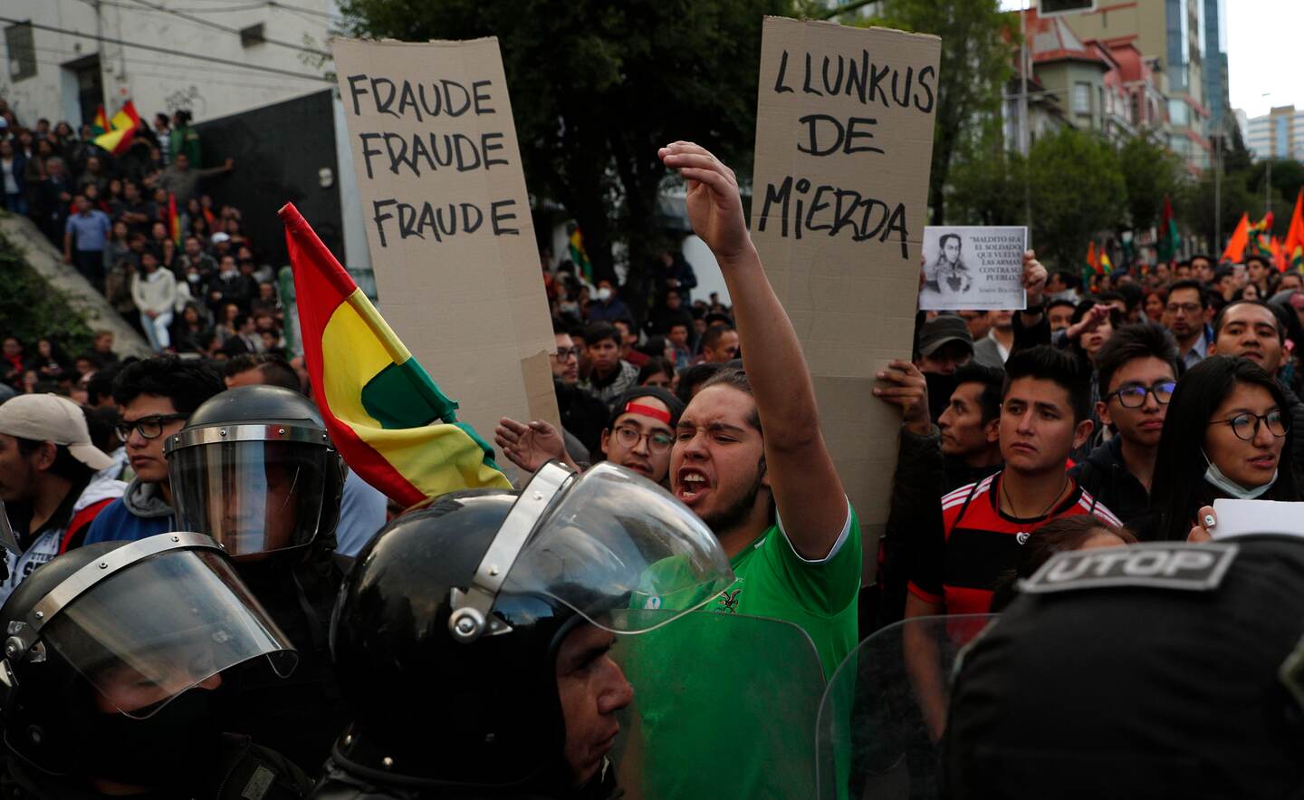 Supporters of opposition presidential candidate Carlos Mesa, a former president, rally outside the Supreme Electoral Court where election ballots are being counted in La Paz, Bolivia, Monday, Oct. 21, 2019. A sudden halt in release of presidential election returns led to confusion and protests in Bolivia on Monday as opponents suggested officials were trying to help President Evo Morales avoid a risky runoff. (AP Photo/Juan Karita)