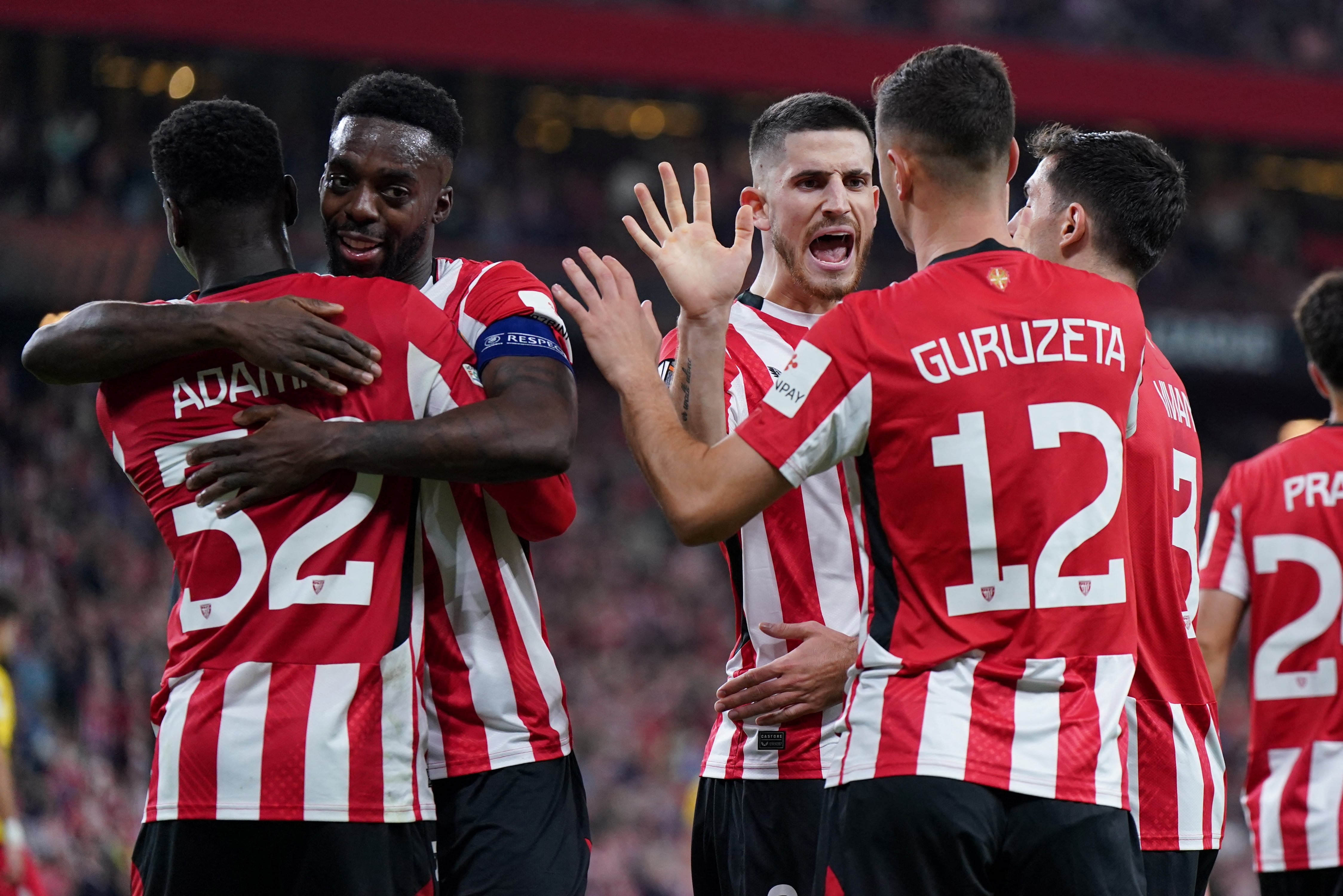 Athletic Bilbao's Spanish forward #12 Gorka Guruzeta (back) celebrates with teammates scoring his team's third goal during the UEFA Europa League 1st round day 5 football match between Athletic Club Bilbao and IF Elfsborg at the San Mames stadium in Bilbao on November 28, 2024. (Photo by CESAR MANSO / AFP)