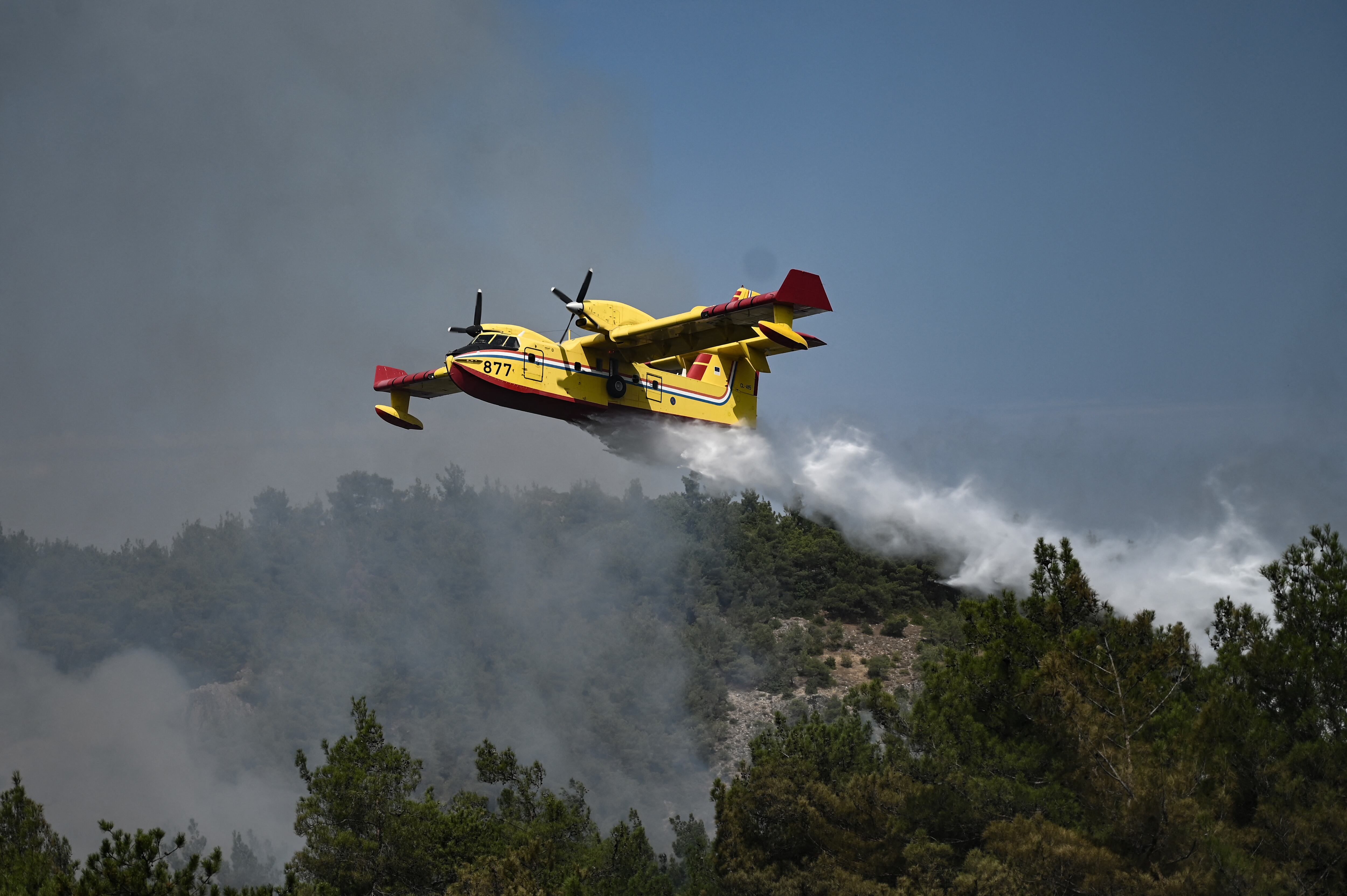 Una fotografía tomada el 24 de agosto de 2023 muestra un avión anfibio de Canadair arrojando agua sobre los incendios forestales que se propagan en el bosque de Dadia, cerca de Alexandroupoli, al norte de Grecia