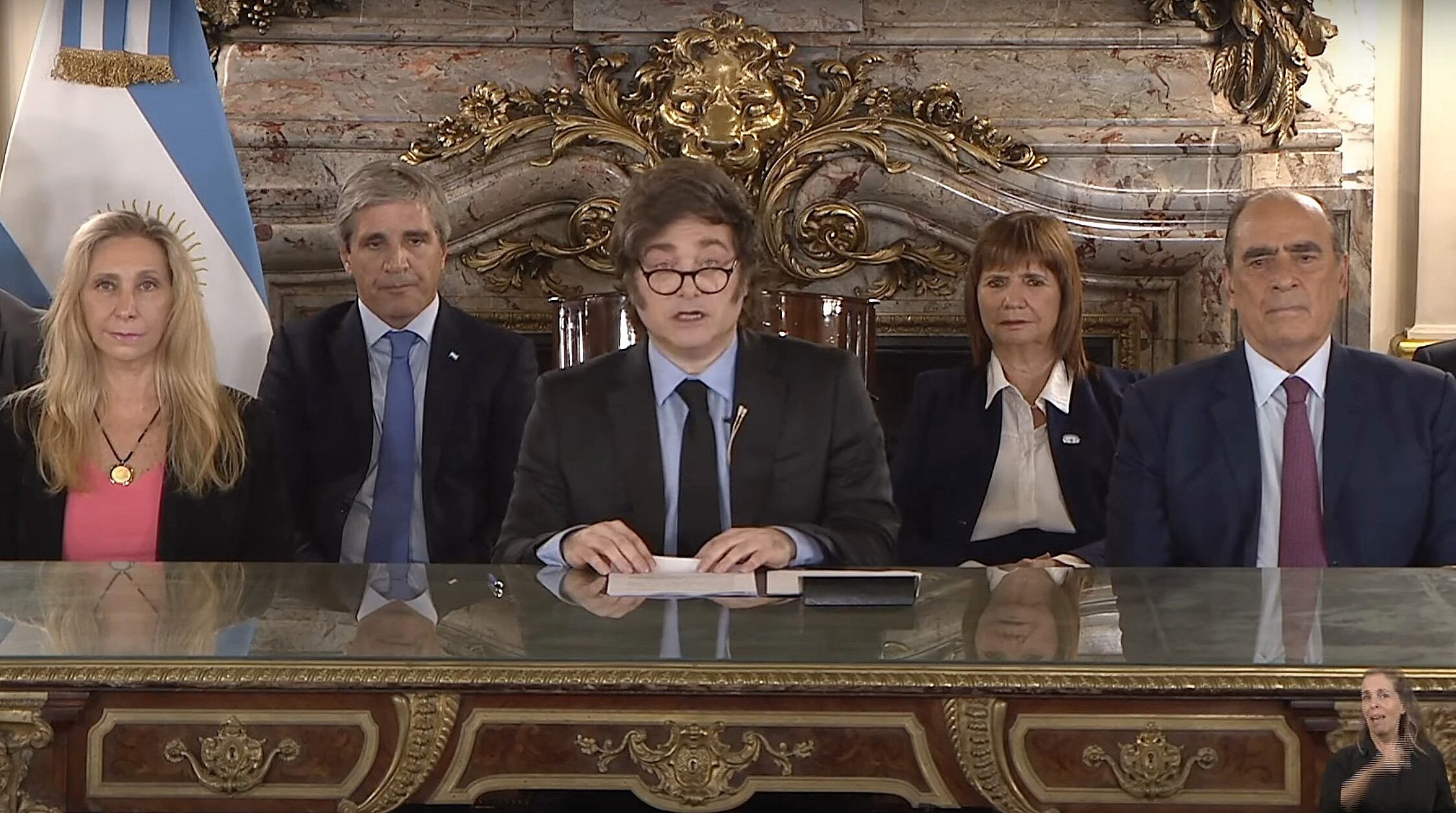 This screen grab taken on April 11, 2025, from an official government TV broadcast shows Argentina's President Javier Milei (C) announcing the new agreement with the IMF (International Monetary Fund) surrounded by the Secretary General of the Presidency Karina Milei (L), the Economy Minister Luis Caputo (2-L), the National Security Minister Patricia Bullrich (2-R), and Chief Cabinet Guillermo Francos at the Casa Rosada Presidential Palace in Buenos Aires. The president of Argentina, Javier Milei, assured that the country will grow �as never before� after the liberation of exchange controls and the agreement with the International Monetary Fund (IMF) for a loan of 20 billion dollars, announced this Friday. (Photo by Argentina's Presidency Press Office / AFP) / RESTRICTED TO EDITORIAL USE - MANDATORY CREDIT "AFP PHOTO / ARGENTINA'S PRESIDENCY" - NO MARKETING NO ADVERTISING CAMPAIGNS - DISTRIBUTED AS A SERVICE TO CLIENTS