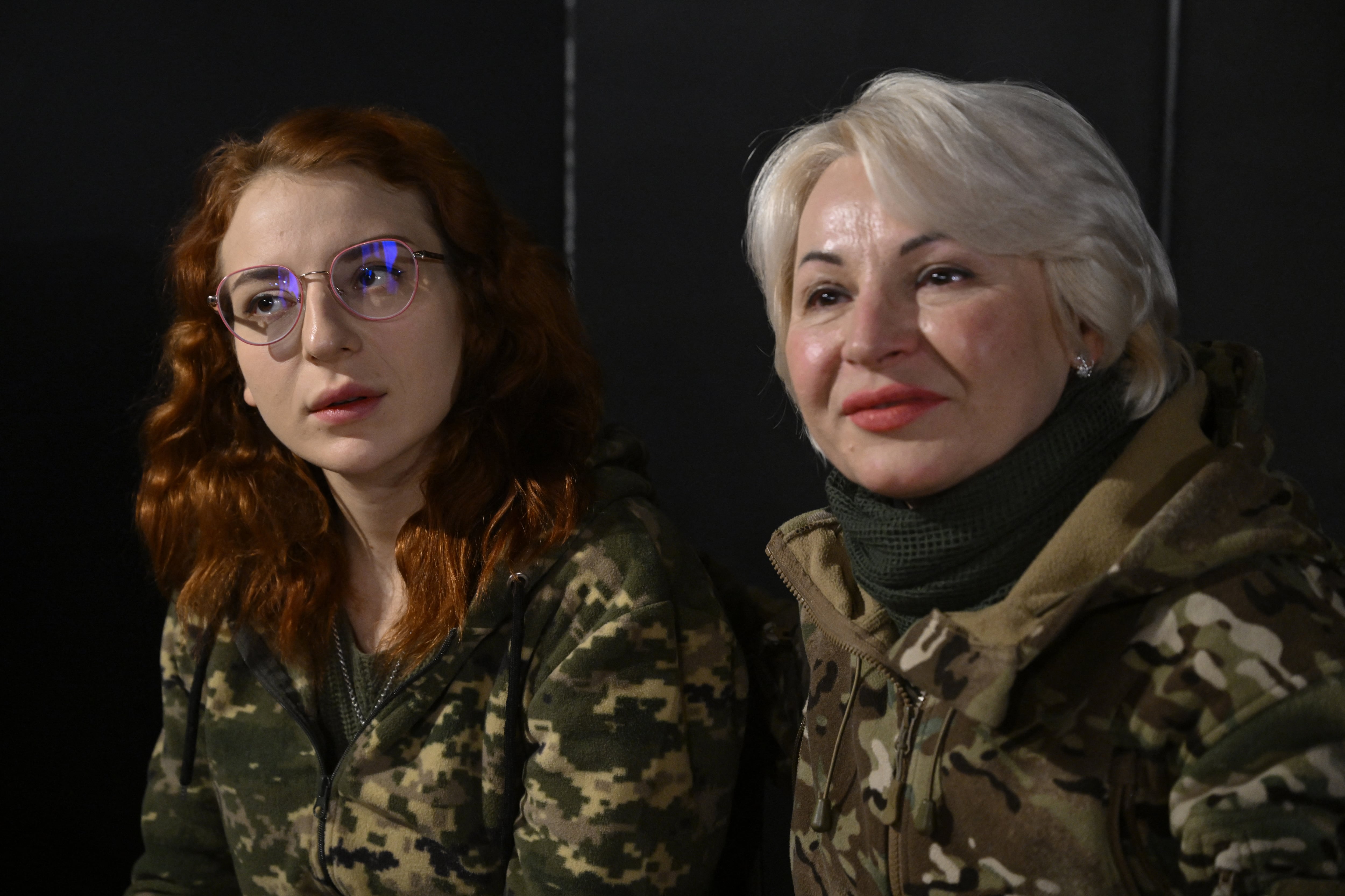 Ukrainian servicewomen Natalia (R), 53, and her daughter Veronika (L), 26, from the 100th mechanized brigade, pose for a photo during an AFP interview at an undisclosed location in the Donetsk region on February 15, 2025, amid the Russian invasion of Ukraine. Natalia gave up her job as a clothing des