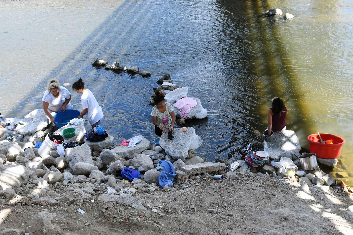 Mujeres lavan ropa y trastos de cocina en las contaminadas aguas del río Lempa en Citala, 100 kilómetros al norte de San Salvador.