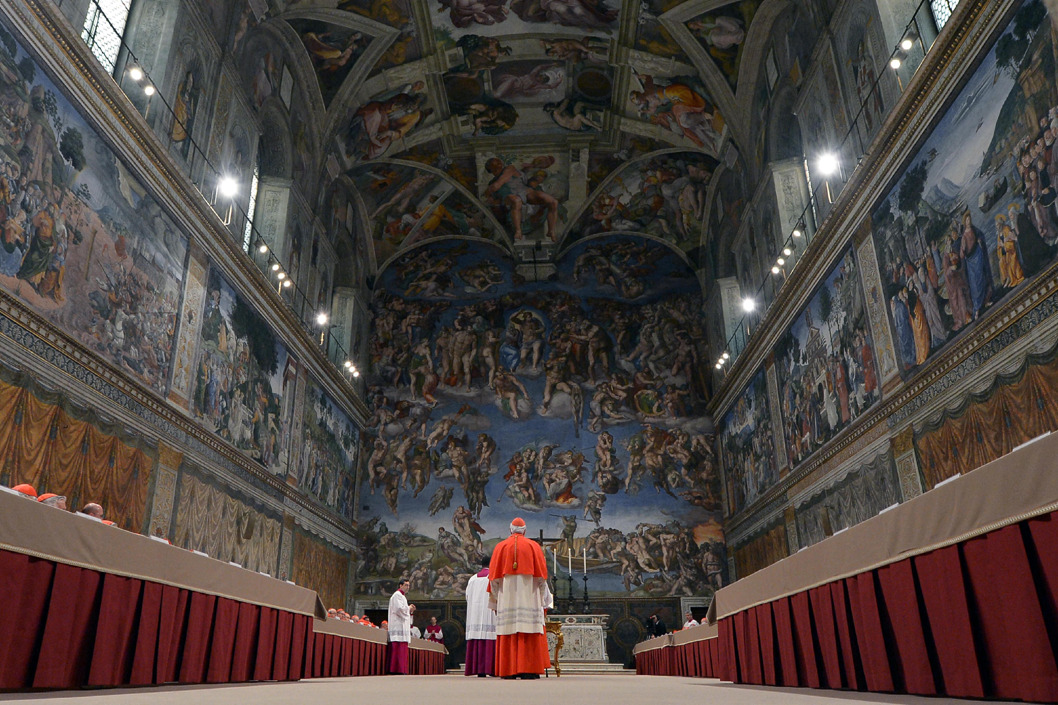 (FILES) This handout picture released by the Press office shows cardinals queuing in the Sistine Chapel to swear on the Bible to never reveal the secrets of their deliberations before the start of the conclave at the Vatican on March 12, 2013. Catholic cardinals meeting in Rome on April 28, 2025, agreed to begin on May 7, 2025, the conclave to elect a successor to Pope Francis, according to ANSA news agency. On Wednesday May 7, the cardinals will take part in a solemn mass at St Peter's Basilica in the Vatican, after which those eligible to vote will gather in the Sistine Chapel for the secretive ballot, which can last several days. (Photo by Handout / OSSERVATORE ROMANO / AFP) / RESTRICTED TO EDITORIAL USE - MANDATORY CREDIT "AFP PHOTO / OSSERVATORE ROMANO" - HANDOUT - NO MARKETING NO ADVERTISING CAMPAIGNS - DISTRIBUTED AS A SERVICE TO CLIENTS