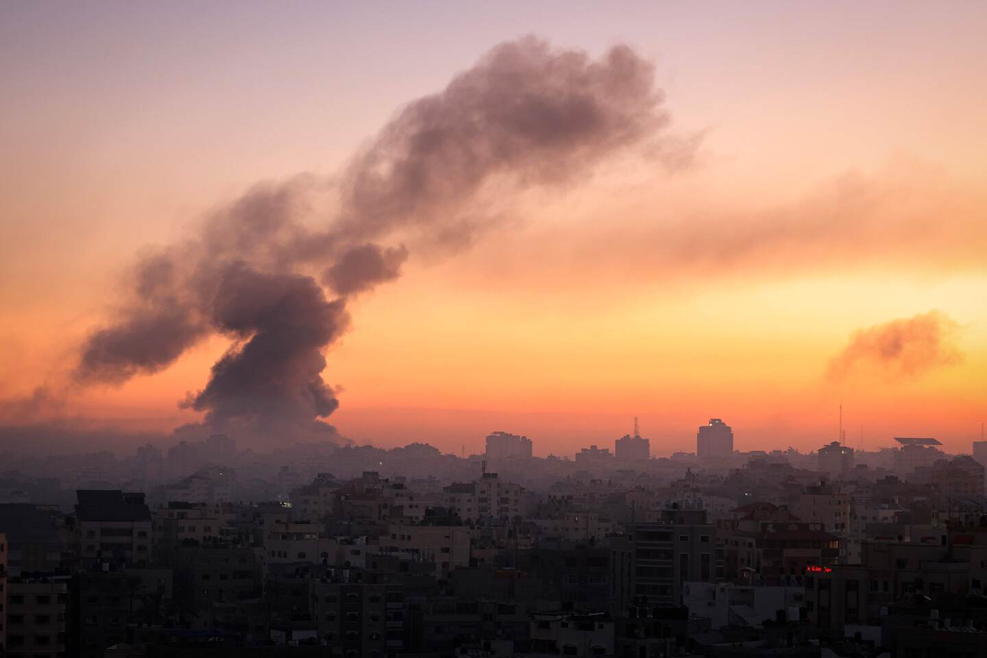 TOPSHOT - Fire and smoke rise above buildings in Gaza City during an Israeli air strike, on October 13, 2023, as raging battles between Israel and the Hamas movement continue for the sixth consecutive day. The United Nations was informed that Israel had ordered 1.1 million residents of northern Gaza to relocate to the south of the territory within 24 hours, a UN spokesperson told AFP on October 13, 2023, calling for the order to be rescinded on humanitarian grounds. (Photo by MAHMUD HAMS / AFP)