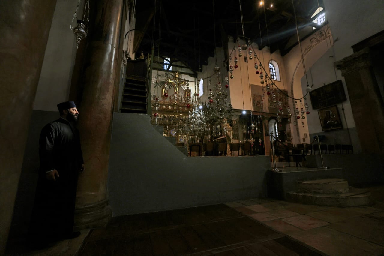 Un sacerdote camina dentro de la Iglesia de la Natividad en la ciudad bíblica de Belén, Cisjordania ocupada, el 17 de diciembre de 2024.