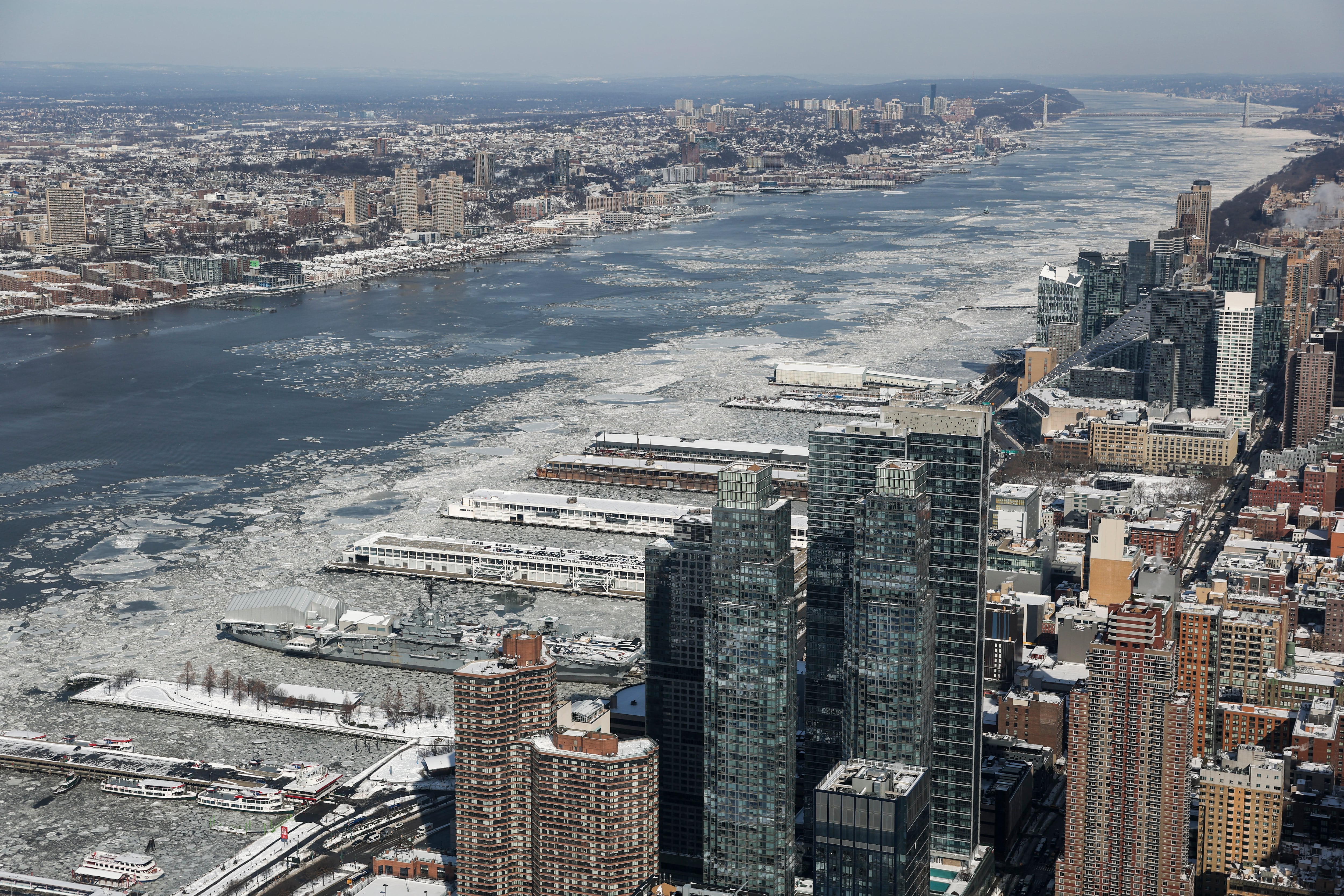 An aerial view of an icy Hudson River during freezing temperatures, seen from the Edge observation deck in New York City on January 28, 2026. A life-threatening freeze is gripping large swaths of the United States after a monster storm caused at least 38 deaths from the Deep South to the Northeast, knocked out power to hundreds of thousands and sent air travel into chaos. Another Arctic blast expected this weekend could deliver fresh misery for more than 100 million Americans, with record low temperatures and another major storm threatening -- even as municipalities are digging out from deep piles of snow and ice. (Photo by ANGELA WEISS / AFP)
