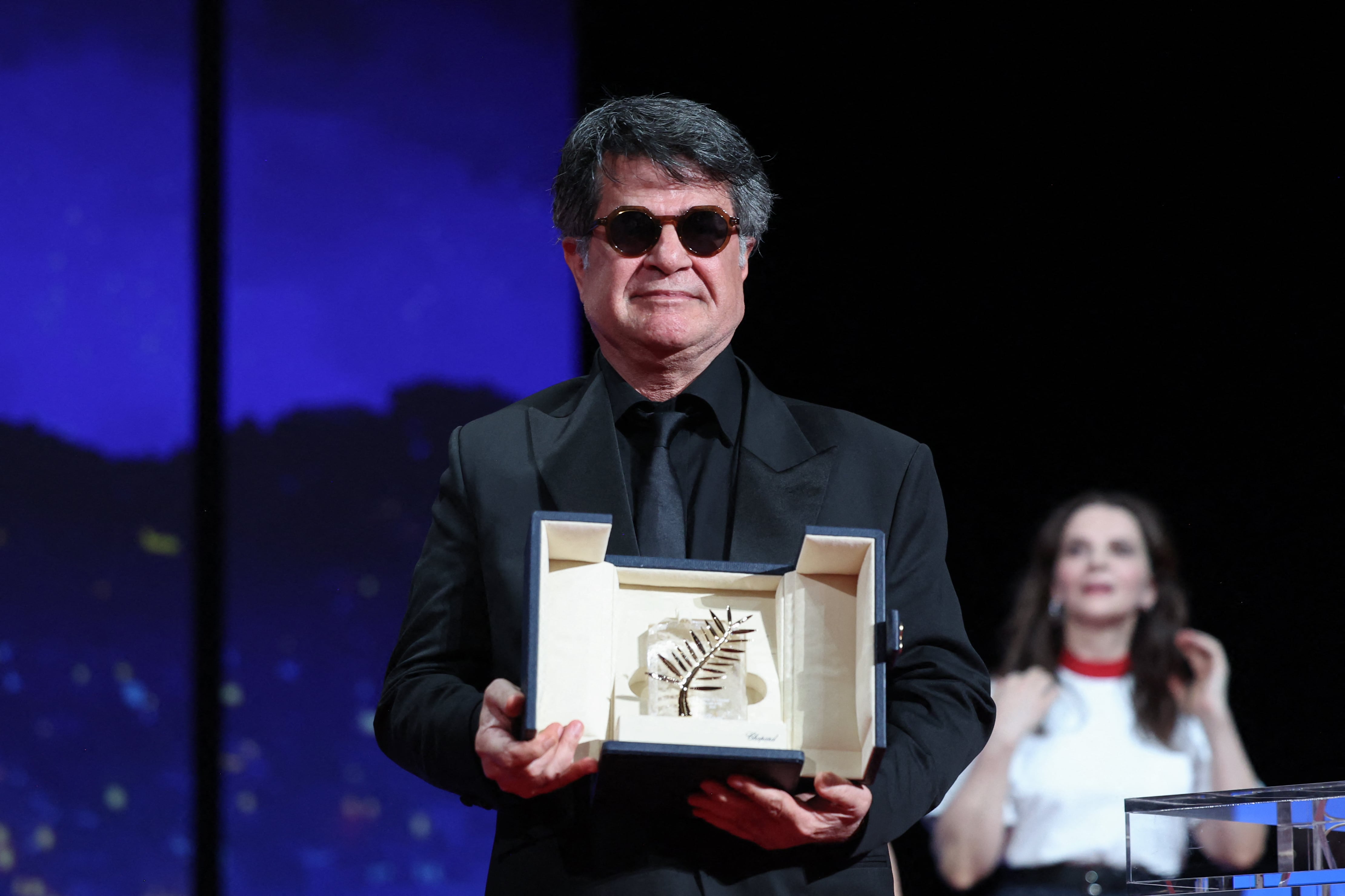 Iranian director and screenwriter and producer Jafar Panahi poses on stage after winning the Palme d'Or for the film "Un simple accident" (A Simple Accident) during the closing ceremony at the 78th edition of the Cannes Film Festival in Cannes, southern France, on May 24, 2025. (Photo by Valery HACHE / AFP)