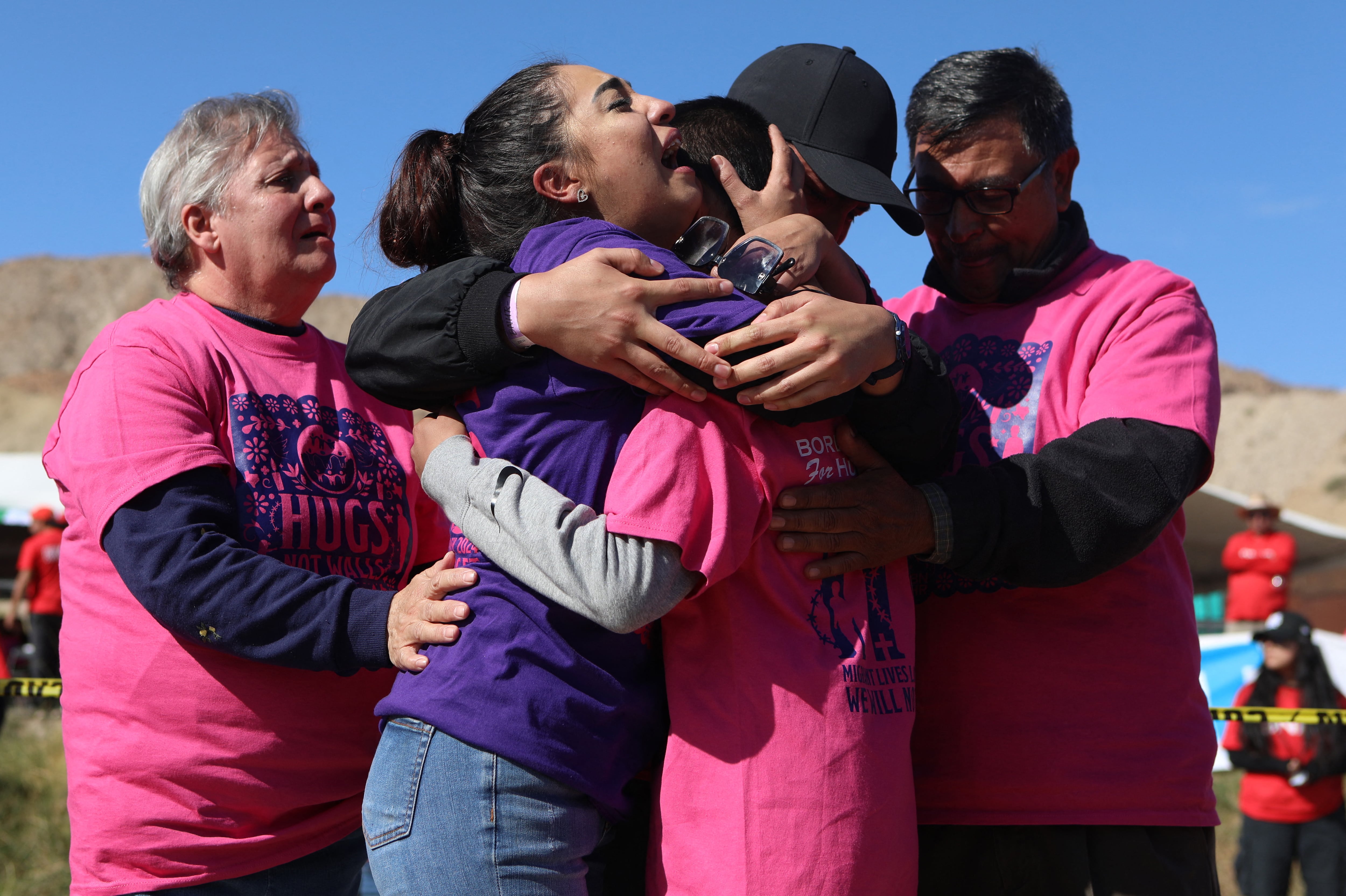 Migrantes se abrazan con sus familiares durante el evento 'Abrazos, no Muros' organizado por la organización estadounidense Border Network for Human Rights en medio del Río Bravo, en la frontera entre El Paso, estado de Texas, Estados Unidos, y Ciudad Juárez, estado de Chihuahua, México.
