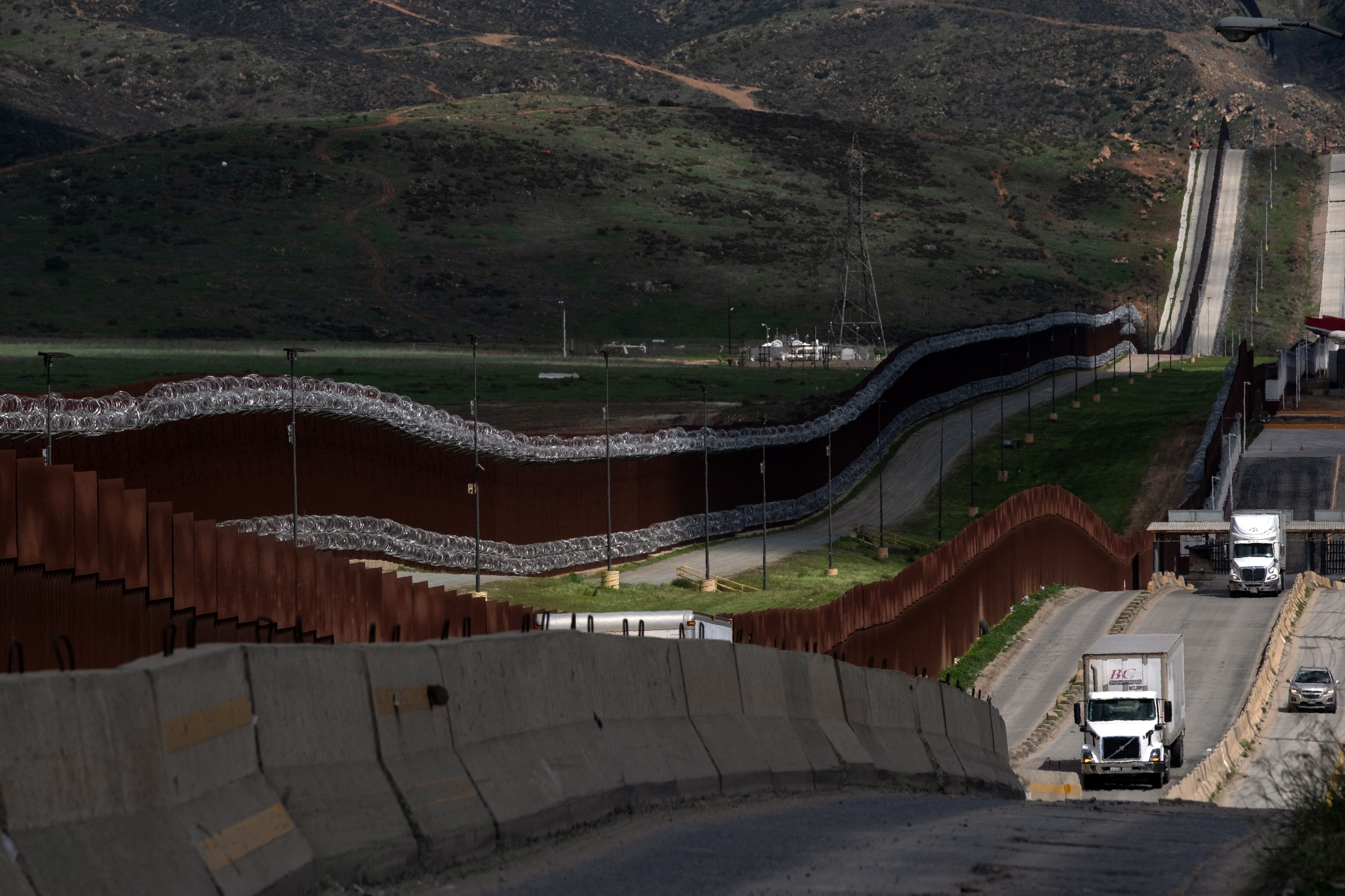 Trucks coming from Mexico enter the United States to an inspection station after crossing the border in Otay Mesa, California, on April 1, 2025. US President Donald Trump kept the world's leading economies on edge on April 1, 2025 as he made final preparations for a "Liberation Day" announcement of sweeping new tariffs that could trigger a global trade war. Trump has promised to be "very kind" when he unveils the so-called reciprocal tariffs on Wednesday, but uncertainty reigned over which countries would be targeted and by how much. (Photo by SANDY HUFFAKER / AFP)