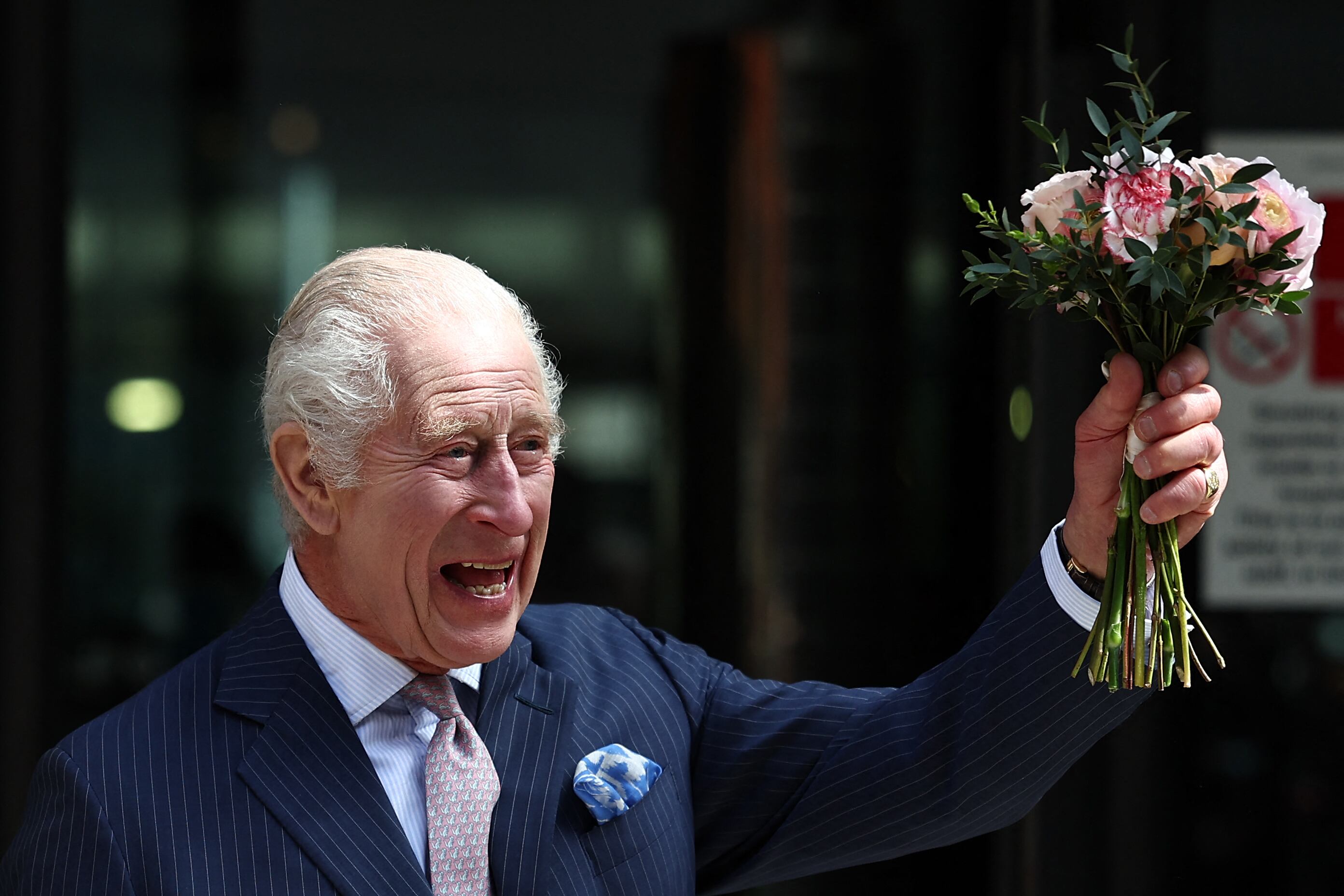 Britain's King Charles III and Britain's Queen Camilla recieve a bouquet of flowers after a visit to the University College Hospital Macmillan Cancer Centre in London on April 30, 2024. Charles is making his first official public appearance since being diagnosed with cancer, after doctors said they were "very encouraged" by the progress of his treatment. (Photo by HENRY NICHOLLS / AFP)