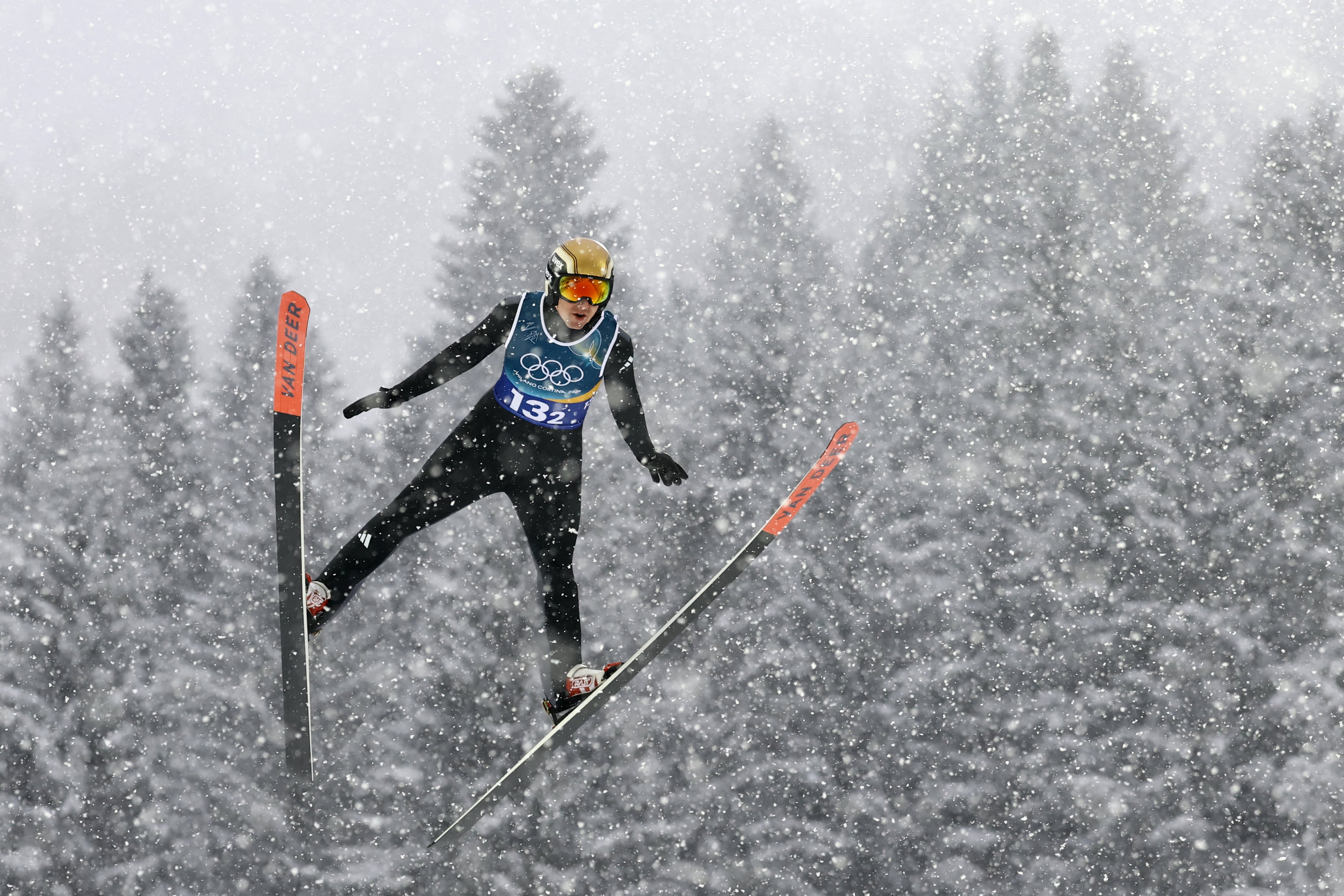Germany's Vinzenz Geiger jumps in the ski jumping competition round of the nordic combined team sprint large hill event at Predazzo Ski Jumping Stadium in Predazzo (Val di Fiemme) during the Milano Cortina 2026 Winter Olympic Games on February 19, 2026. (Photo by Anne-Christine POUJOULAT / AFP)