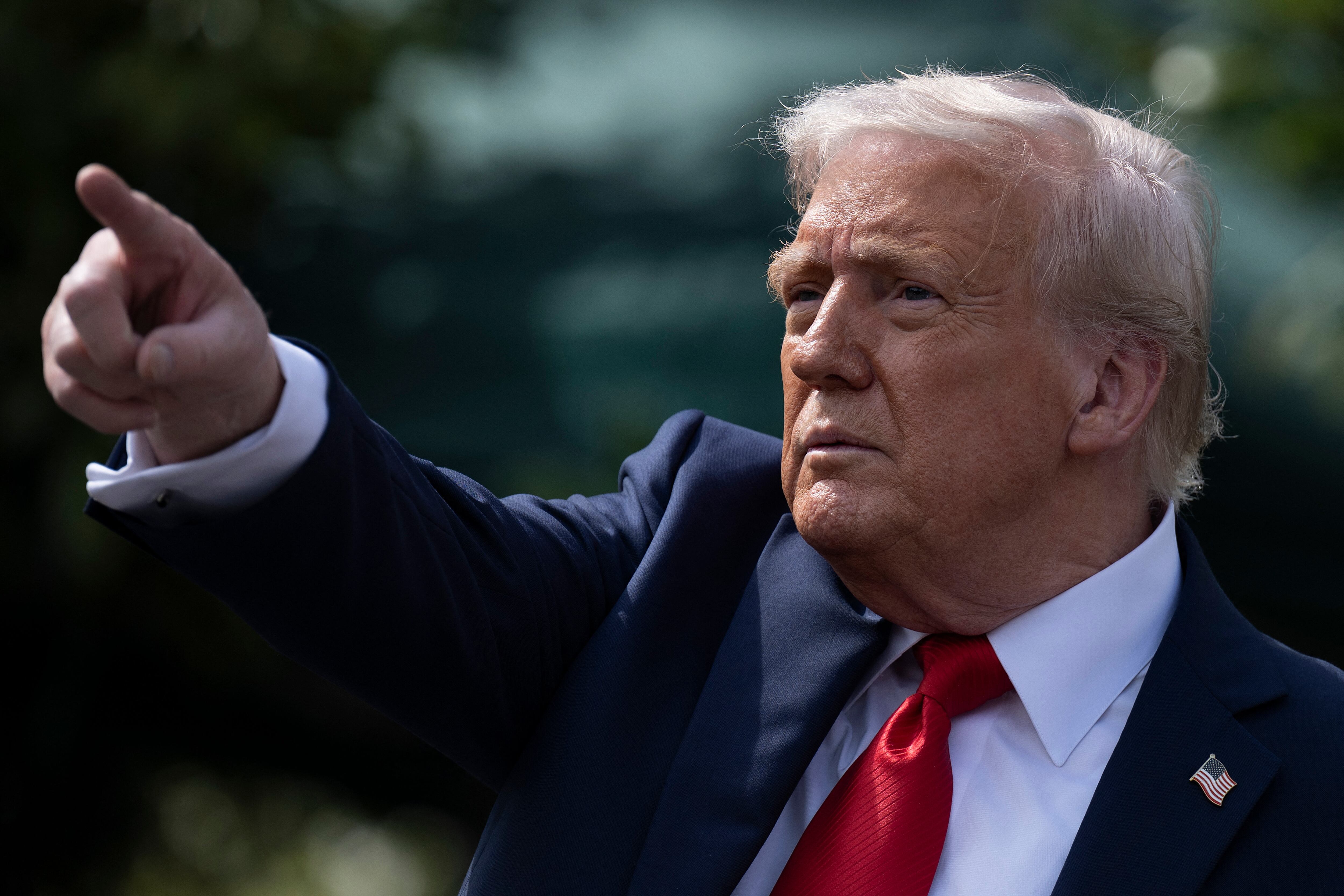 US President Donald Trump gestures after hosting the 2025 College Football National Champions, Ohio State Buckeyes, celebrating the team's title-winning season with a ceremony on the South Lawn of the White House in Washington, DC, April 14, 2025. (Photo by Brendan Smialowski / AFP)