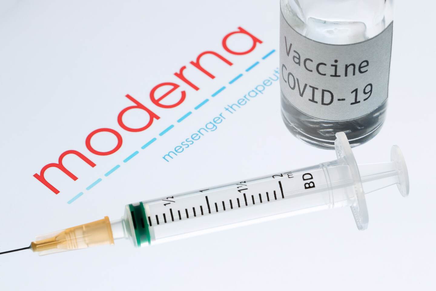 (FILES) This file picture taken on November 18, 2020 shows a syringe and a bottle reading "Vaccine Covid-19" next to the Moderna biotech company logo. - US biotechnology firm Moderna on January 25, 2021 said lab studies showed its Covid-19 vaccine would remain protective against variants of the coronavirus first identified in the United Kingdom and South Africa. "The study showed no significant impact" on the level of neutralizing antibodies elicited against the UK variant, B.1.1.7. (Photo by JOEL SAGET / AFP) / -- IMAGE RESTRICTED TO EDITORIAL USE - STRICTLY NO COMMERCIAL USE --