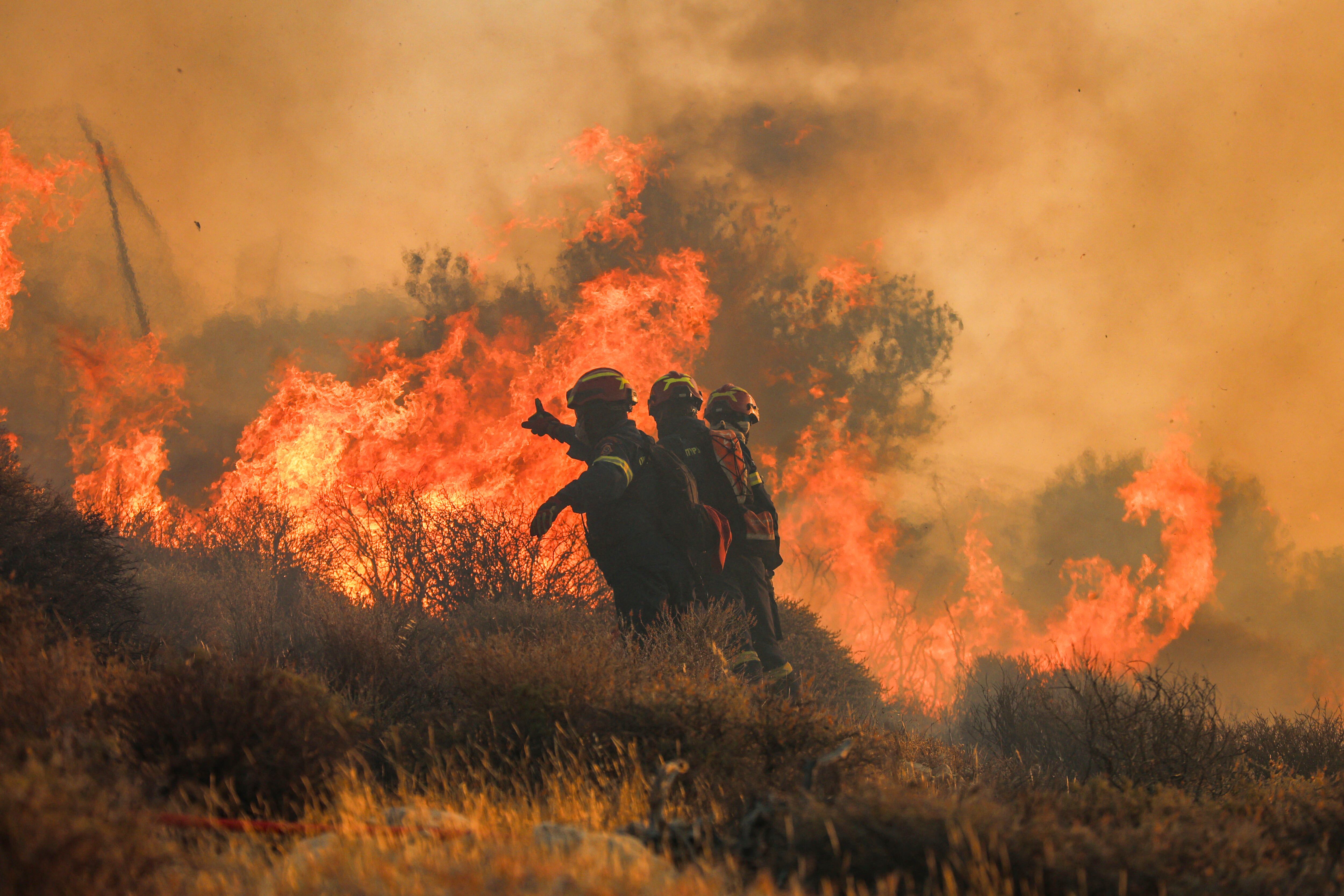 Firemen battle with a wildfire that broke out in Ierapetra at the southern Greek island of Crete, on July 3, 2025. A forest fire fanned by gale-force winds in the Greek holiday island of Crete led to the evacuation of locals and tourists, officials said on July 3, 2025. Greece is in the midst of a heatwave that is searing large chunks of Europe. (Photo by Costas Metaxakis / AFP)