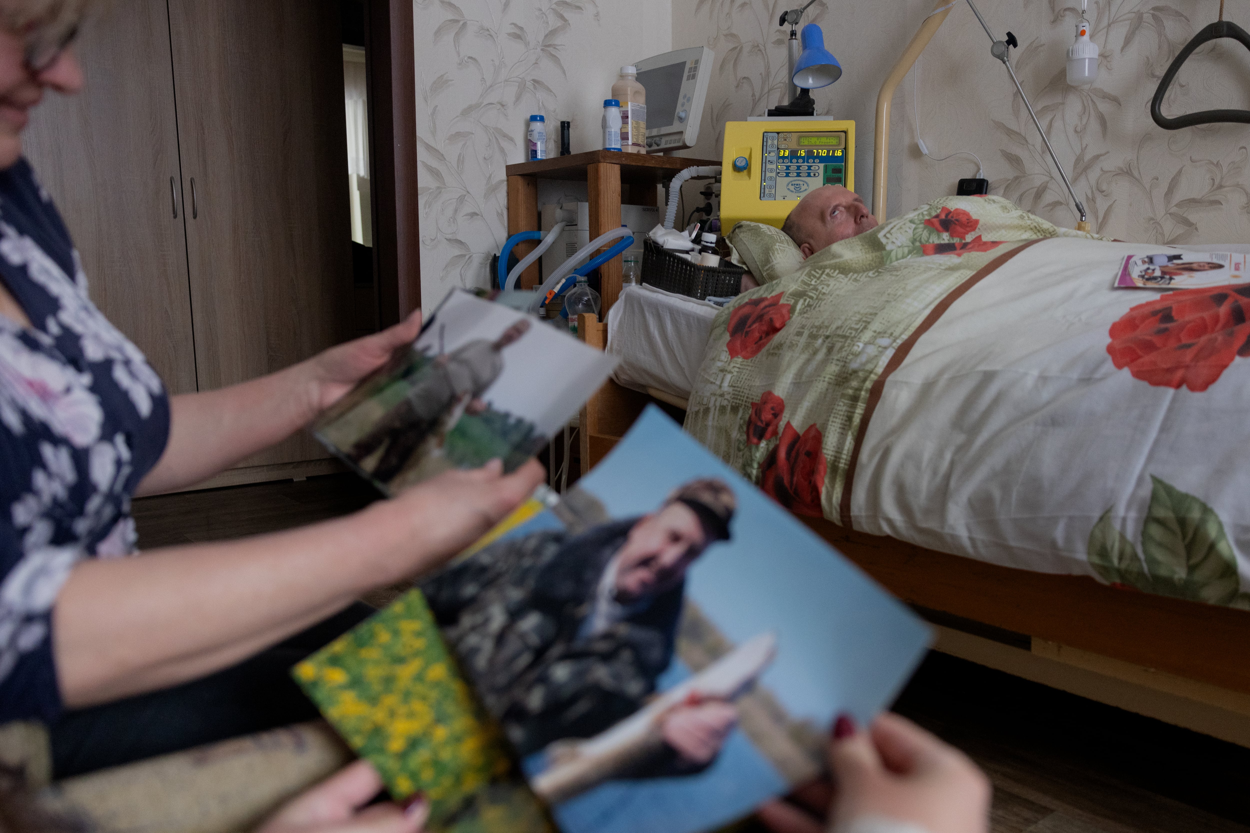 Olena Grygorenko muestra fotos junto a la cama de su esposo Anatoli Kuchynsky en Chernígov el 12 de febrero de 2026, durante la invasión rusa de Ucrania. Olena Grygorenko apenas ha salido de su apartamento en Chernígov en las últimas semanas. Cada vez que se produce un apagón en la ciudad, corre a la cama de su esposo para conectar las baterías de respaldo de su máquina de soporte vital.