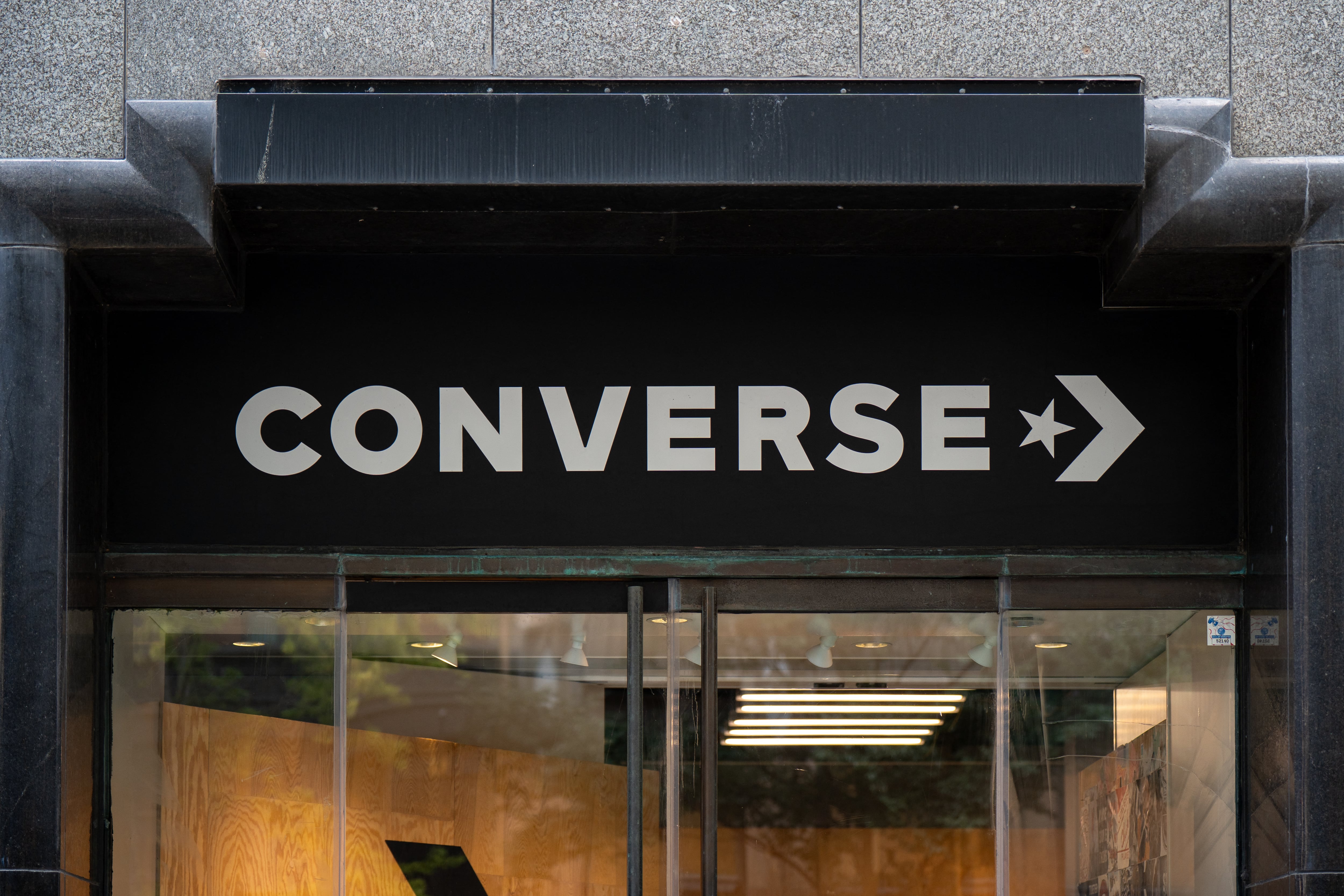 Converse logo sign is seen on a store building in Chicago, Illinois, United States, on July 25, 2026. The signage displays the brand logotype of Converse, an American footwear and apparel company known for its sneakers and casual lifestyle products. (Photo by Marcin Golba/NurPhoto) (Photo by Marcin Golba / NurPhoto via AFP)