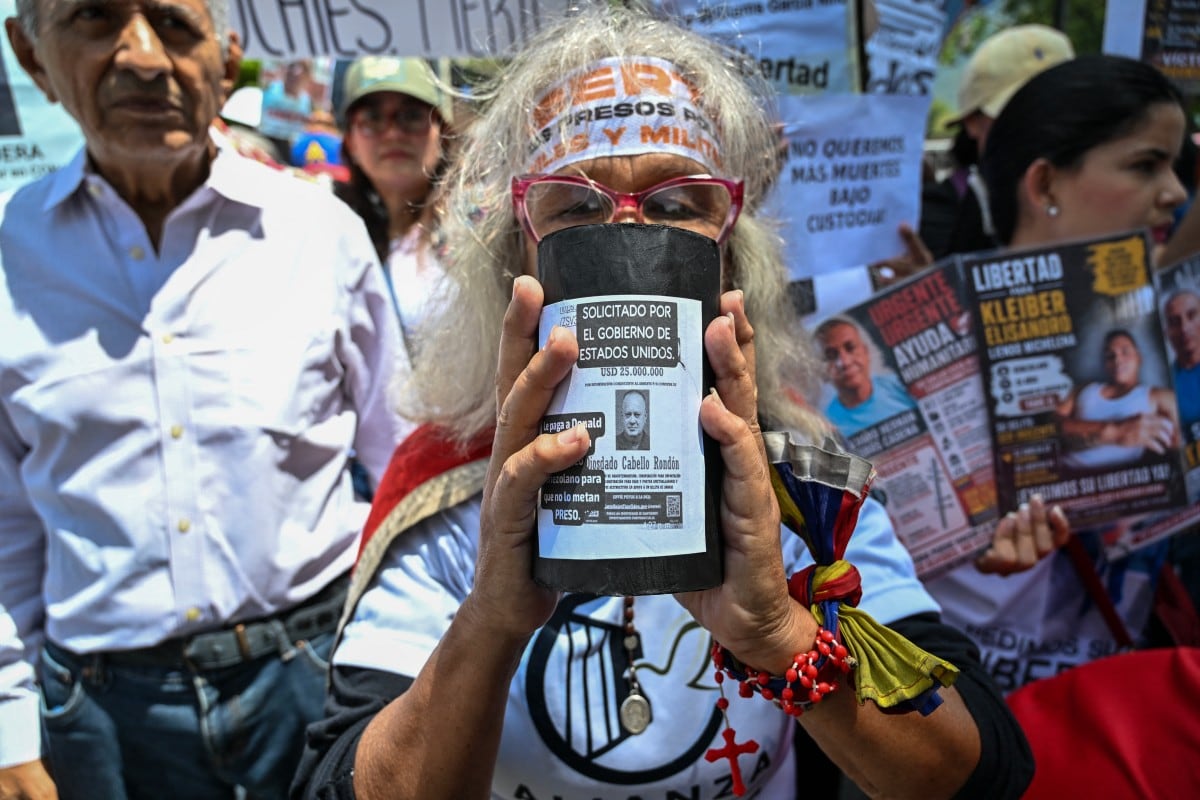 Un familiar de presos políticos sostiene un cartel con la imagen del ministro del Interior de Venezuela, Diosdado Cabello, en el que se lee «Buscado por el Gobierno de Estados Unidos», durante la marcha «¿Cuánto cuesta nuestro petróleo por nuestros presos?», frente al Ministerio de Prisiones, en Caracas, el 1.° de septiembre de 2026.