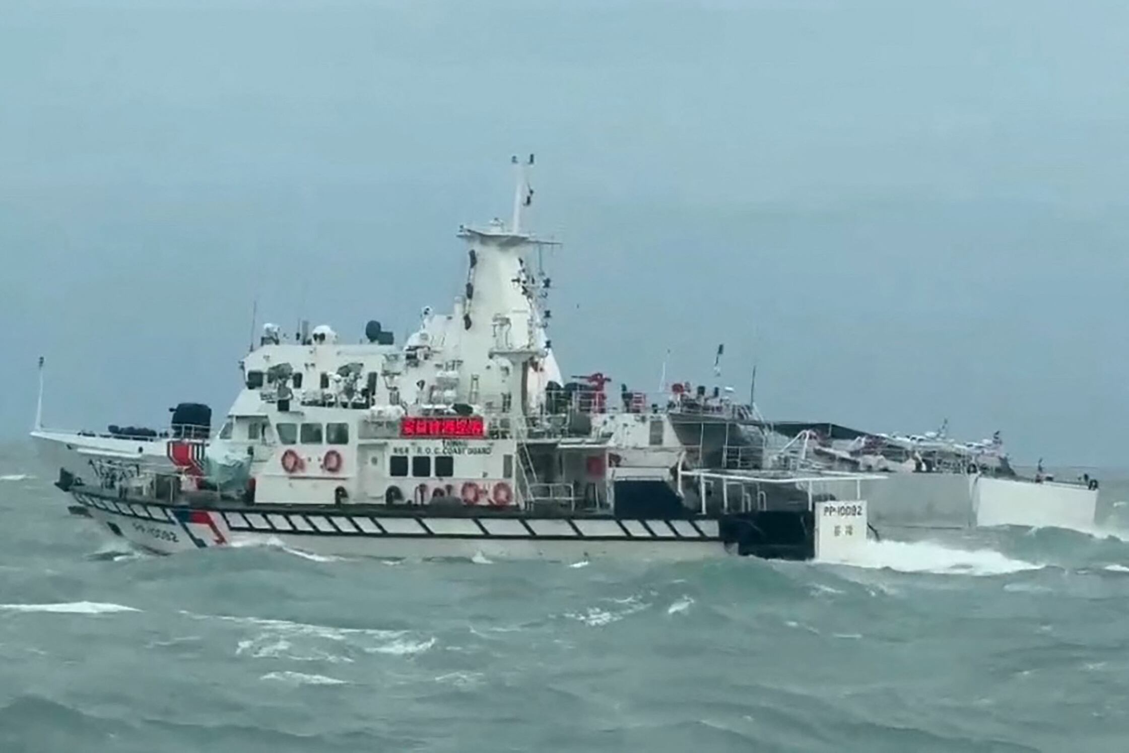 This handout photo taken and released by the Taiwan Coast Guard on April 1, 2025 shows a Taiwan Coast Guard ship (front) and a Chinese Coast Guard ship (back) sailing in waters off the Matsu Islands in Taiwan. China on April 1 sent its army, navy, air and rocket forces to surround Taiwan for drills Beijing said were aimed at practising a blockade of the self-ruled island. (Photo by Handout / TAIWAN COAST GUARD / AFP) / RESTRICTED TO EDITORIAL USE - MANDATORY CREDIT "AFP PHOTO / TAIWAN COAST GUARD" - NO MARKETING NO ADVERTISING CAMPAIGNS - DISTRIBUTED AS A SERVICE TO CLIENTS