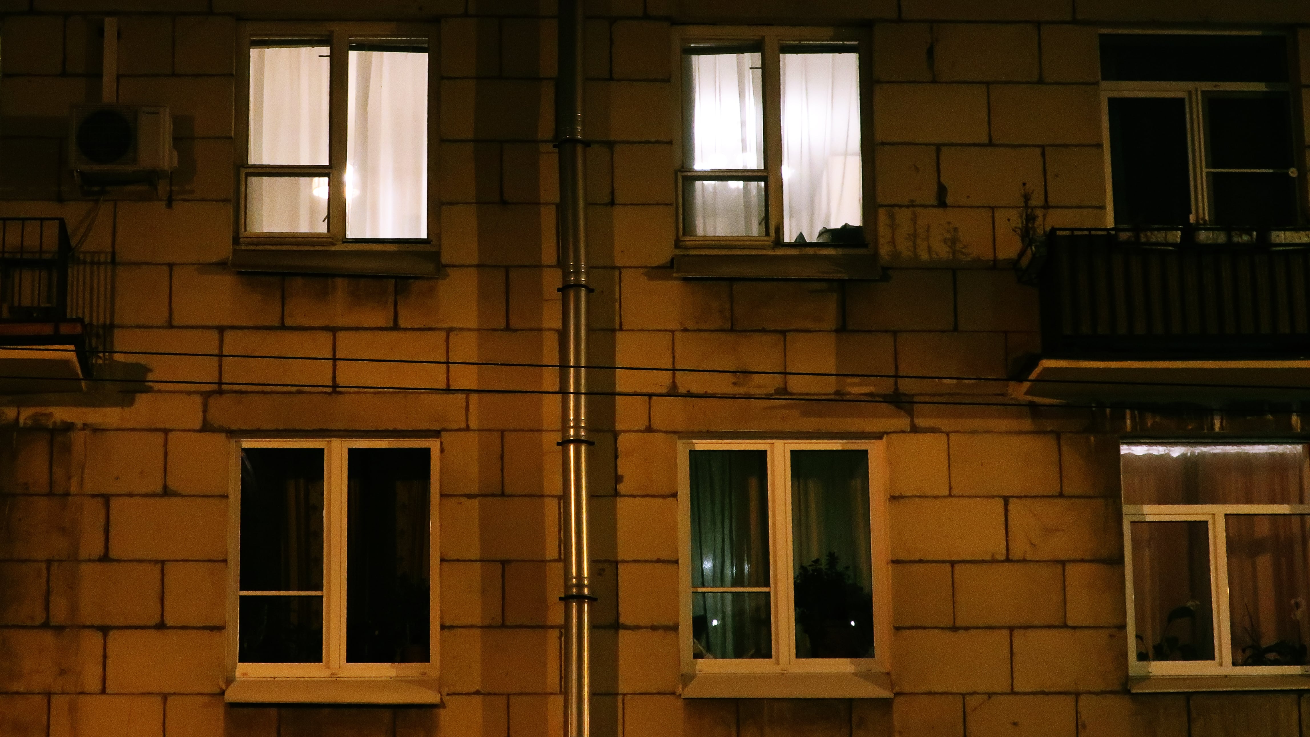 Edificio de noche, con algunas ventanas iluminadas