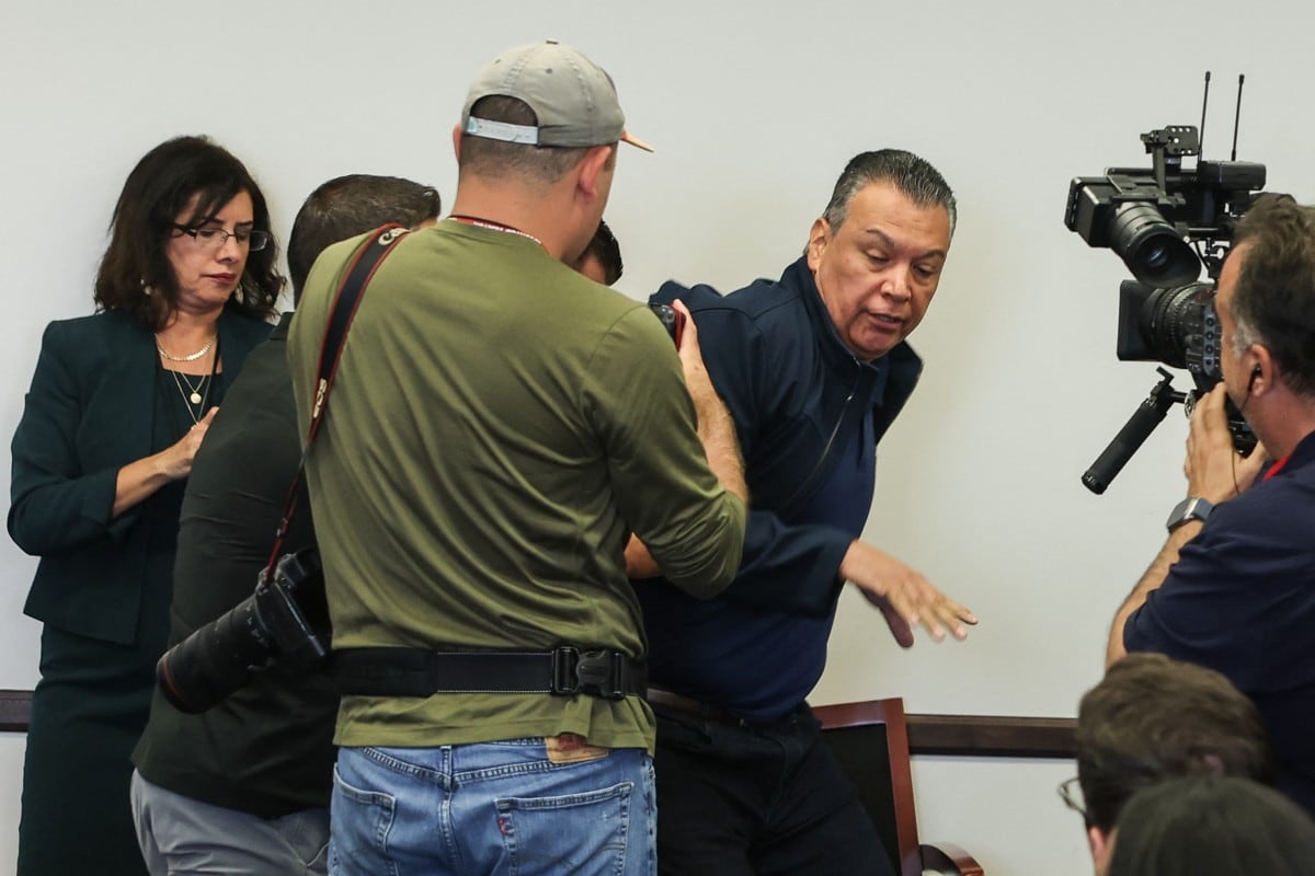 US Senator Alex Padilla, Democrat from California, is removed from the room after interrupting a news conference with Department of Homeland Security Secretary Kristi Noem at the Wilshire Federal Building in Los Angeles on June 12, 2025. US President Donald Trump said Thursday that Los Angeles was "safe and sound" for the past two nights, crediting his deployment of thousands of troops to quell anti-deportation protests, as California prepared for a legal showdown over his unprecedented move. With protests spreading across the United States, a night-time curfew has been in place in its second-largest city with authorities tackling vandalism and looting that scarred a few city blocks. (Photo by Patrick T. Fallon / AFP) / ALTERNATE CROP